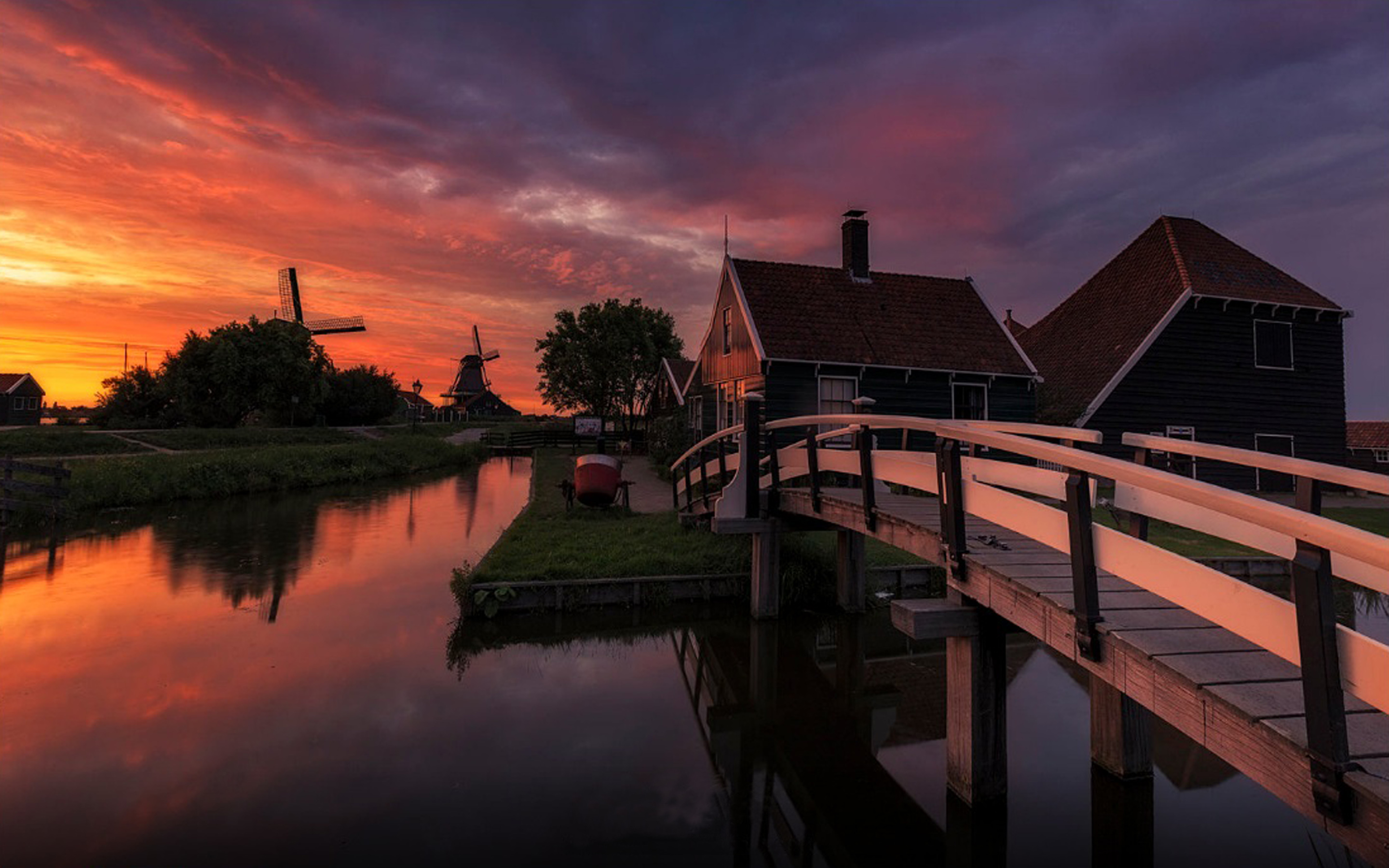 Download mobile wallpaper Sunset, House, Bridge, Netherlands, Windmill, Man Made, Canal for free.