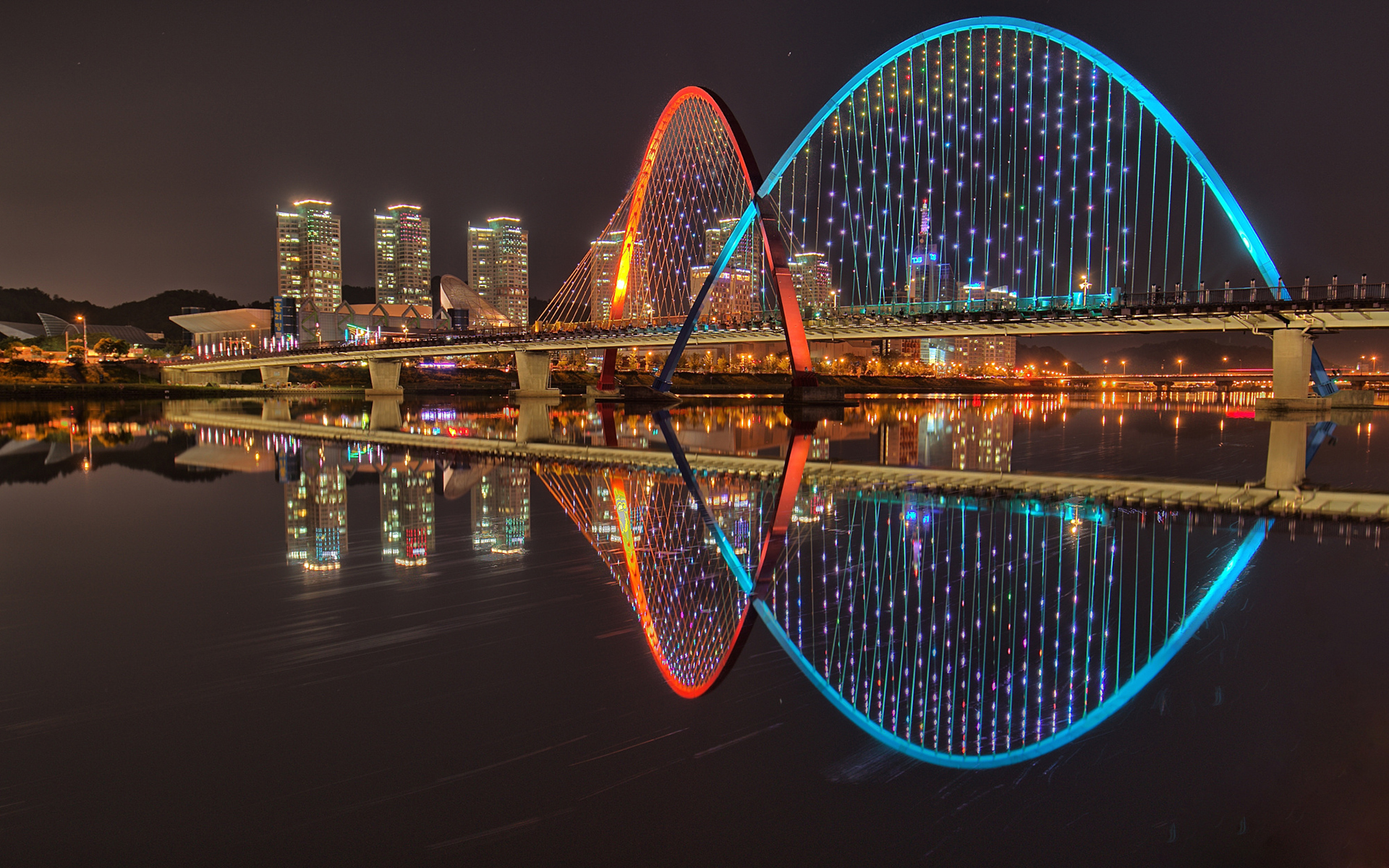 Download mobile wallpaper Cities, Night, City, Reflection, Light, Bridge, Man Made for free.