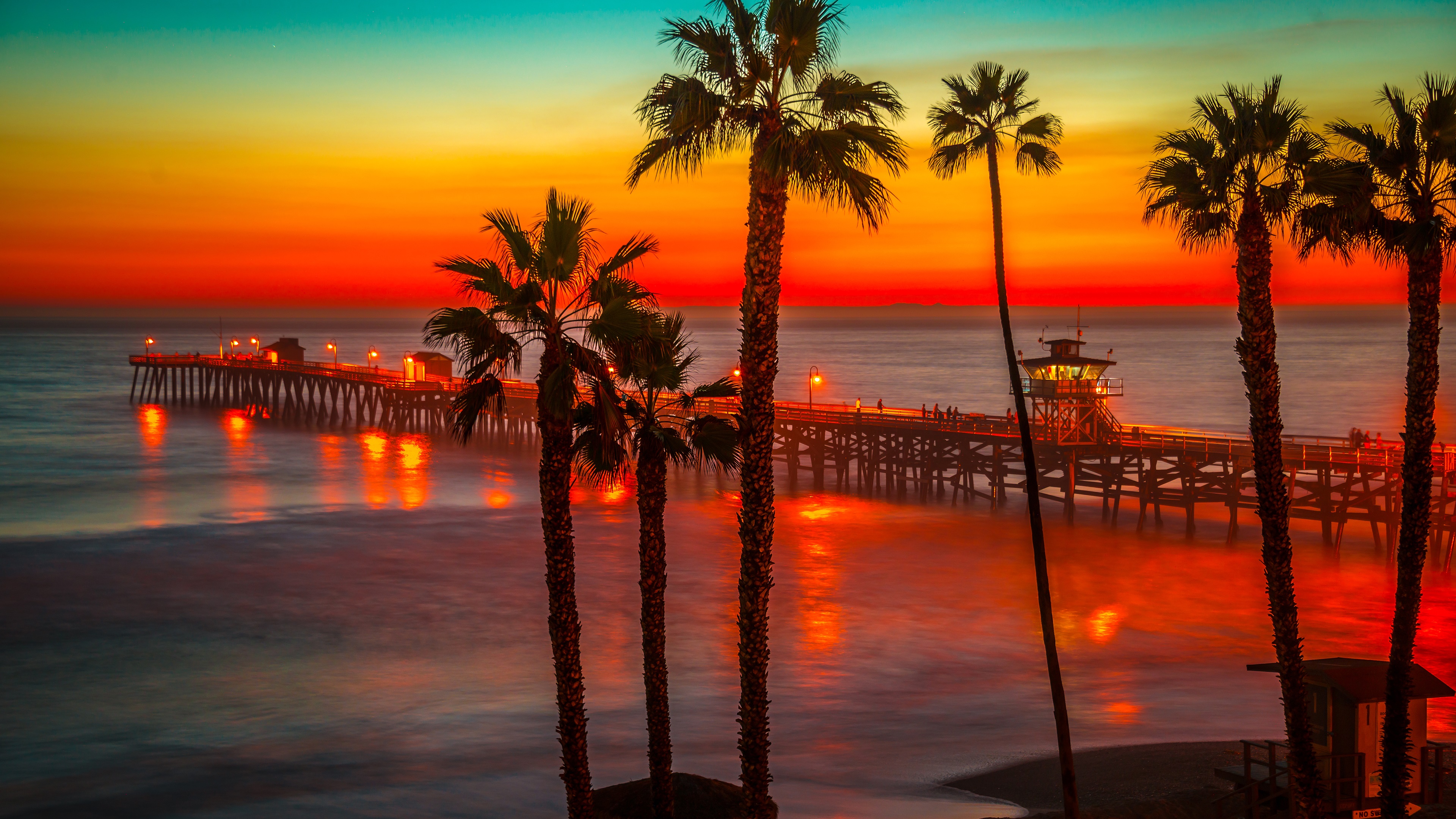 Download mobile wallpaper Sunset, Horizon, Pier, Silhouette, Ocean, Man Made, Palm Tree for free.