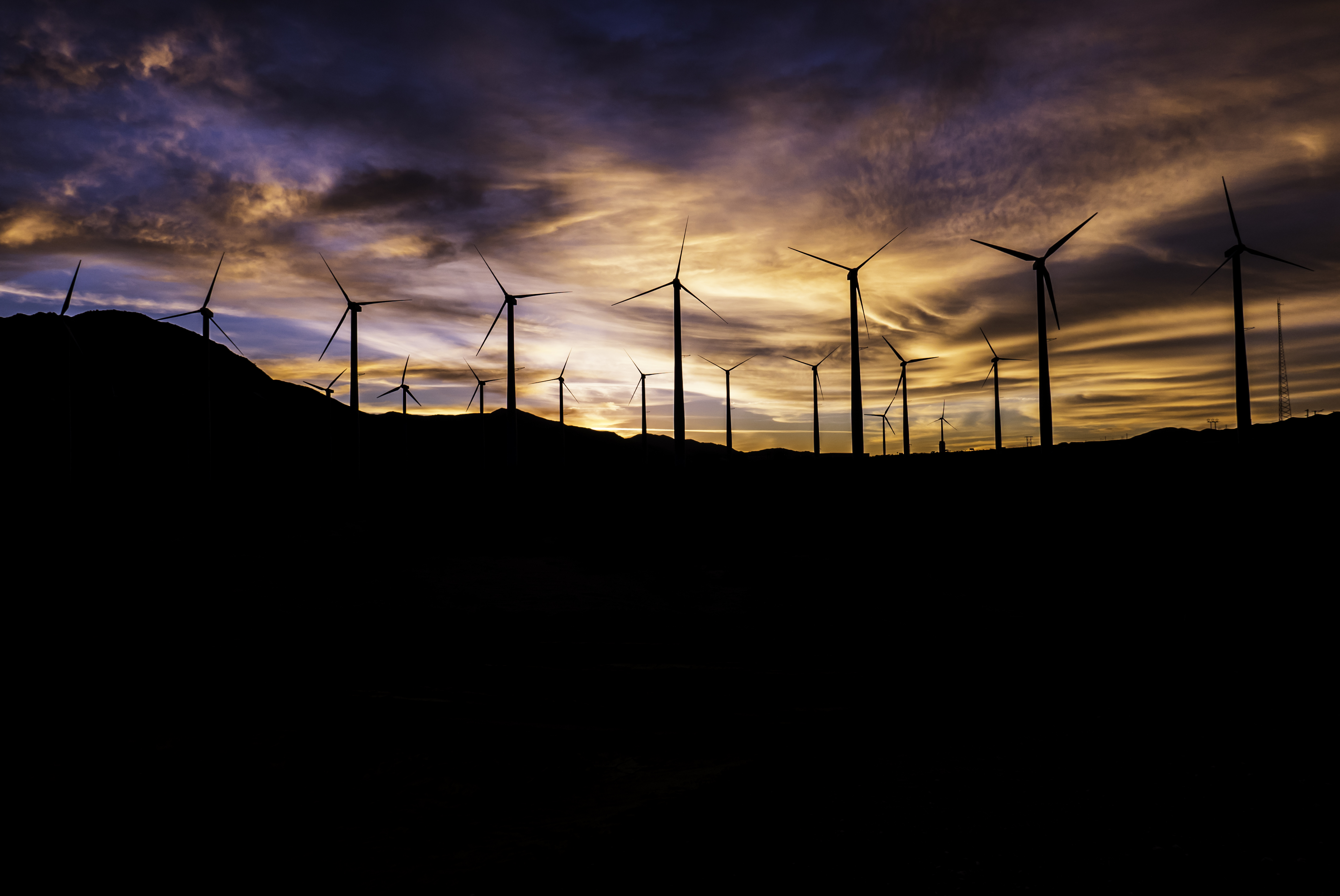 Download mobile wallpaper Sunset, Sky, Silhouette, Wind Turbine, Man Made for free.