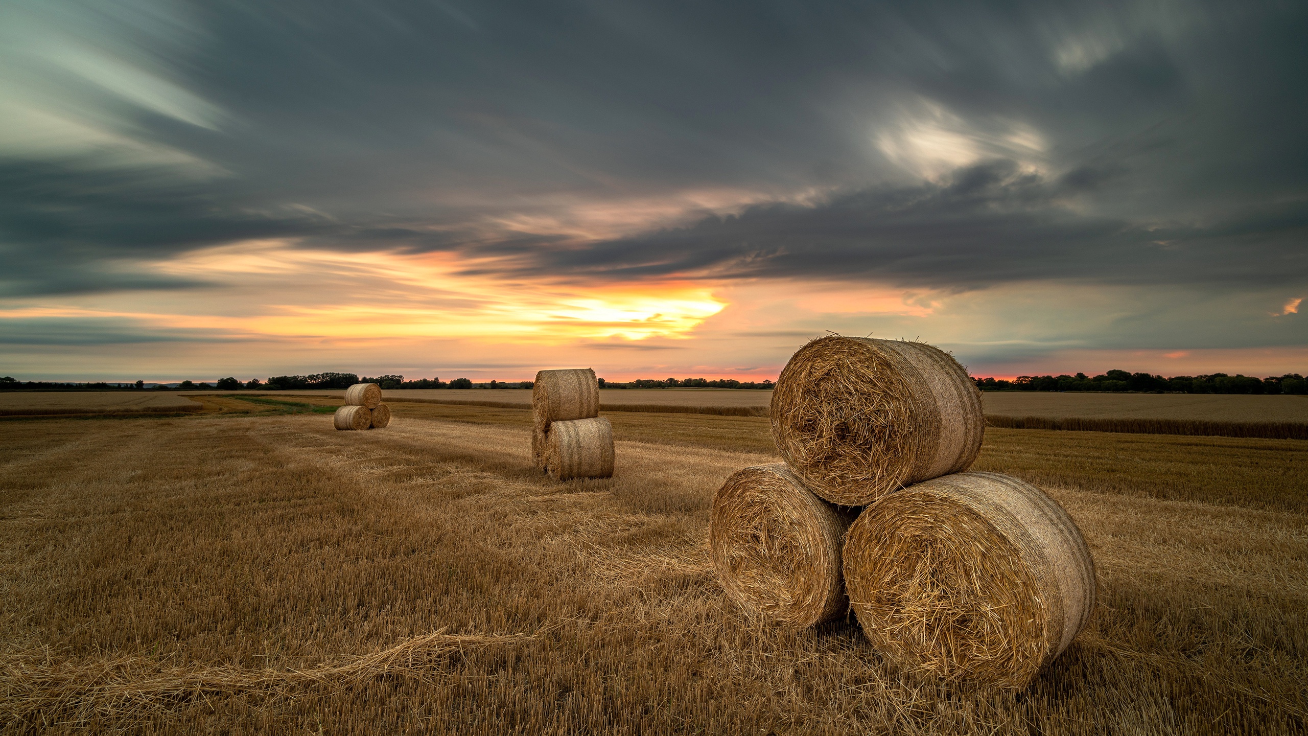 Download mobile wallpaper Sunset, Sky, Earth, Field, Evening, Haystack for free.