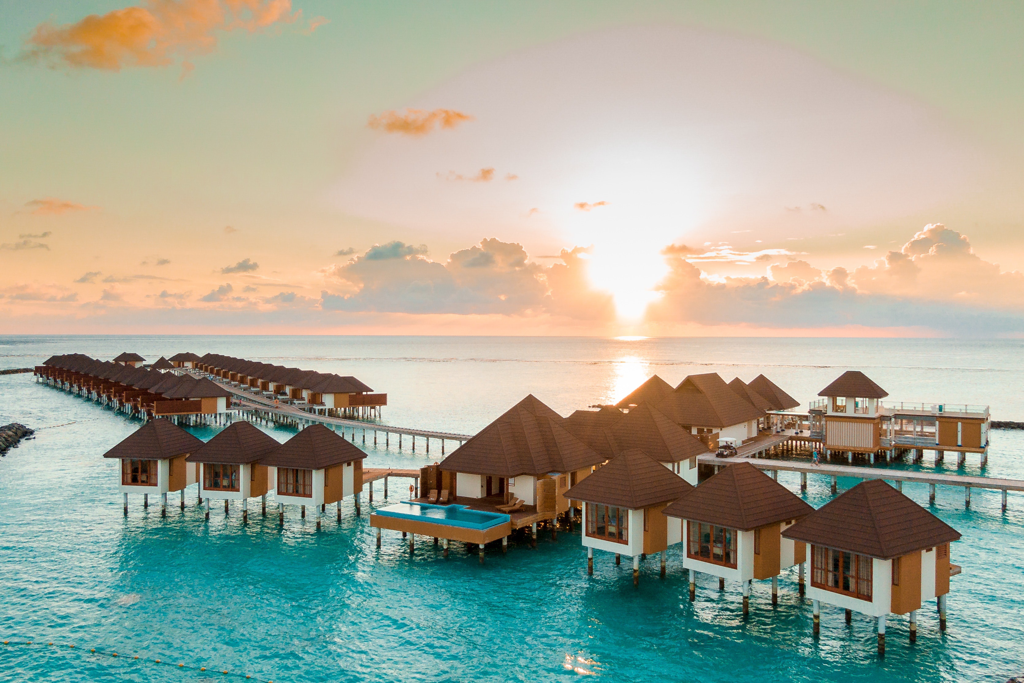 Download mobile wallpaper Sea, Sun, Sunrise, Resort, Maldives, Bungalow, Man Made for free.