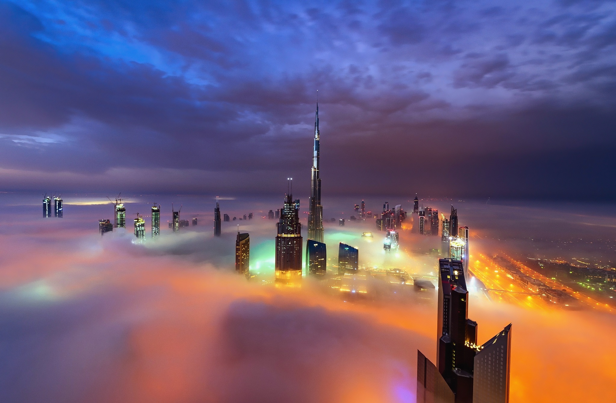 Free download wallpaper Cities, Night, City, Skyscraper, Building, Horizon, Light, Fog, Dubai, Cloud, United Arab Emirates, Man Made on your PC desktop