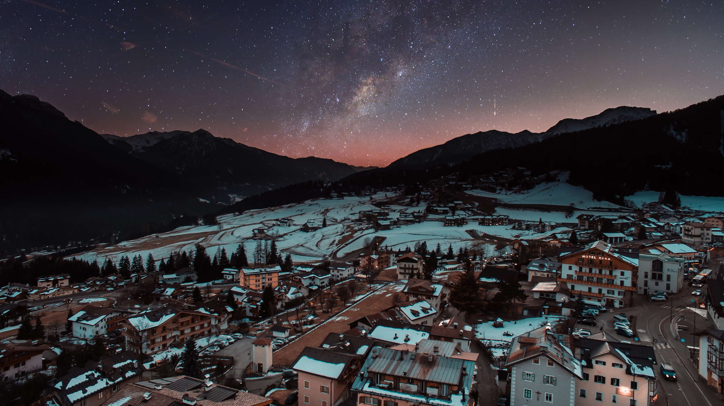 Download mobile wallpaper Winter, Stars, Night, Snow, Mountain, Starry Sky, House, Milky Way, Town, Man Made, Towns for free.