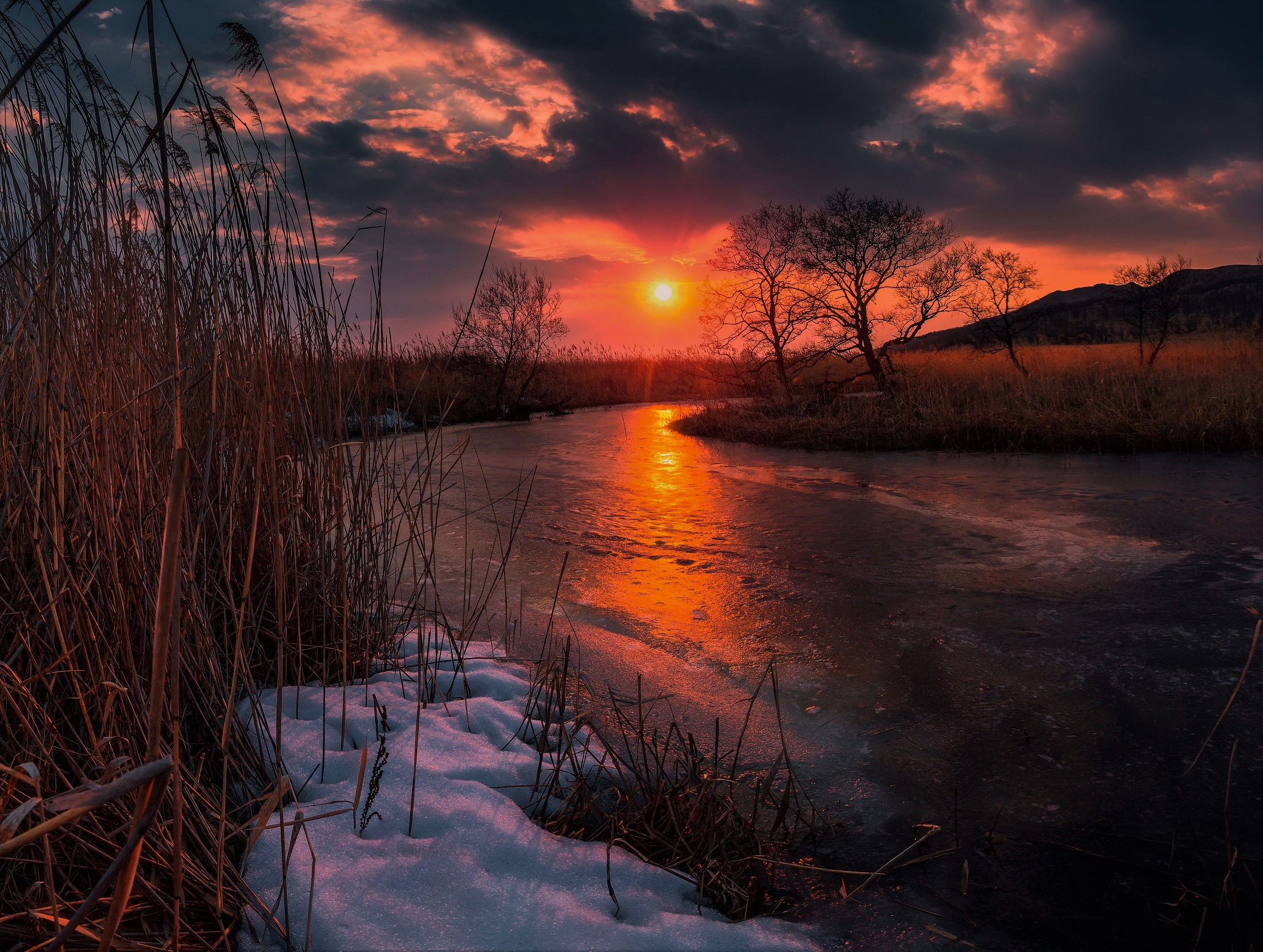 Download mobile wallpaper Winter, Sunset, Sun, Snow, Earth, River, Orange (Color) for free.