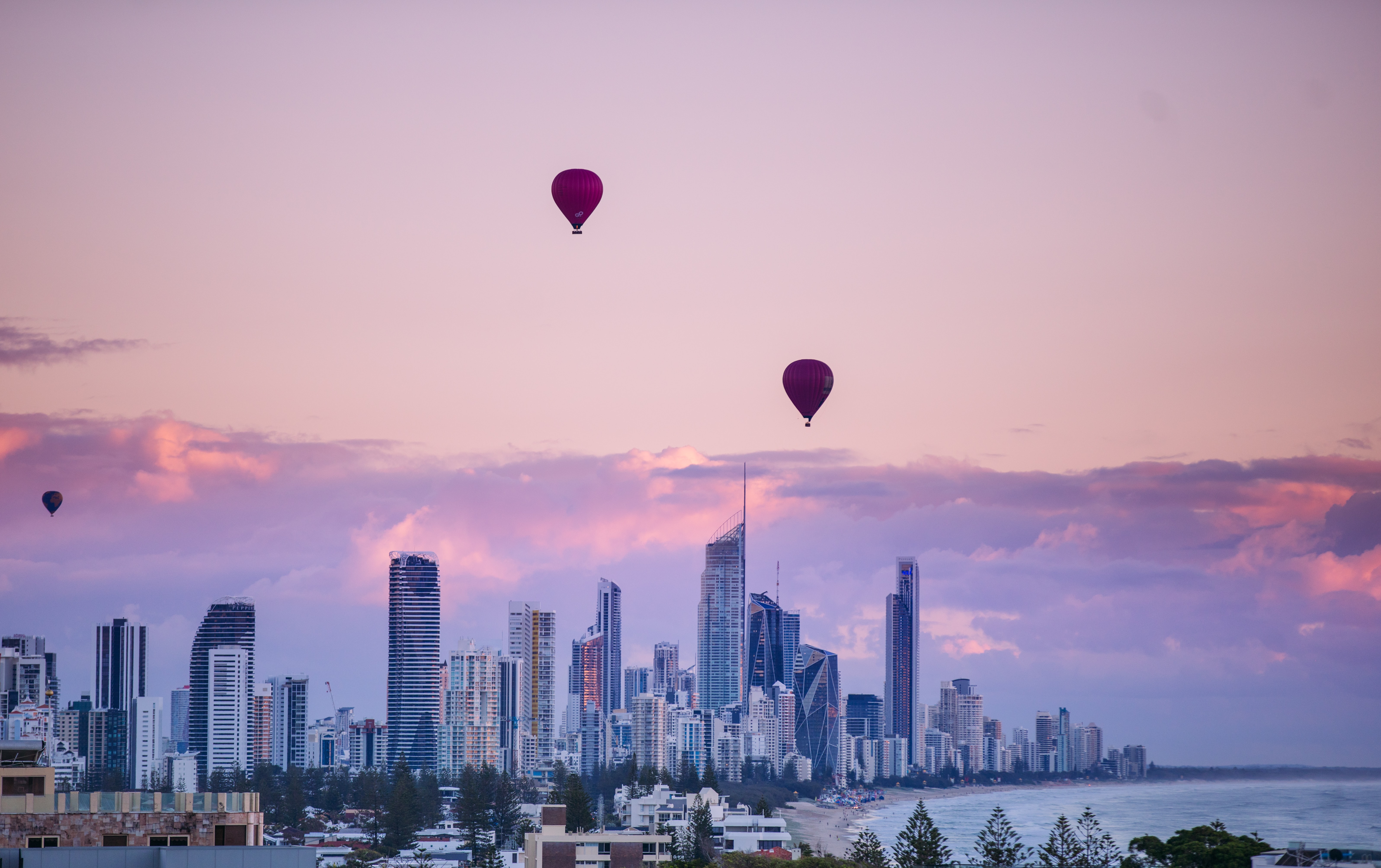 Download mobile wallpaper Balloon, Building, Cities, City, Sunset for free.