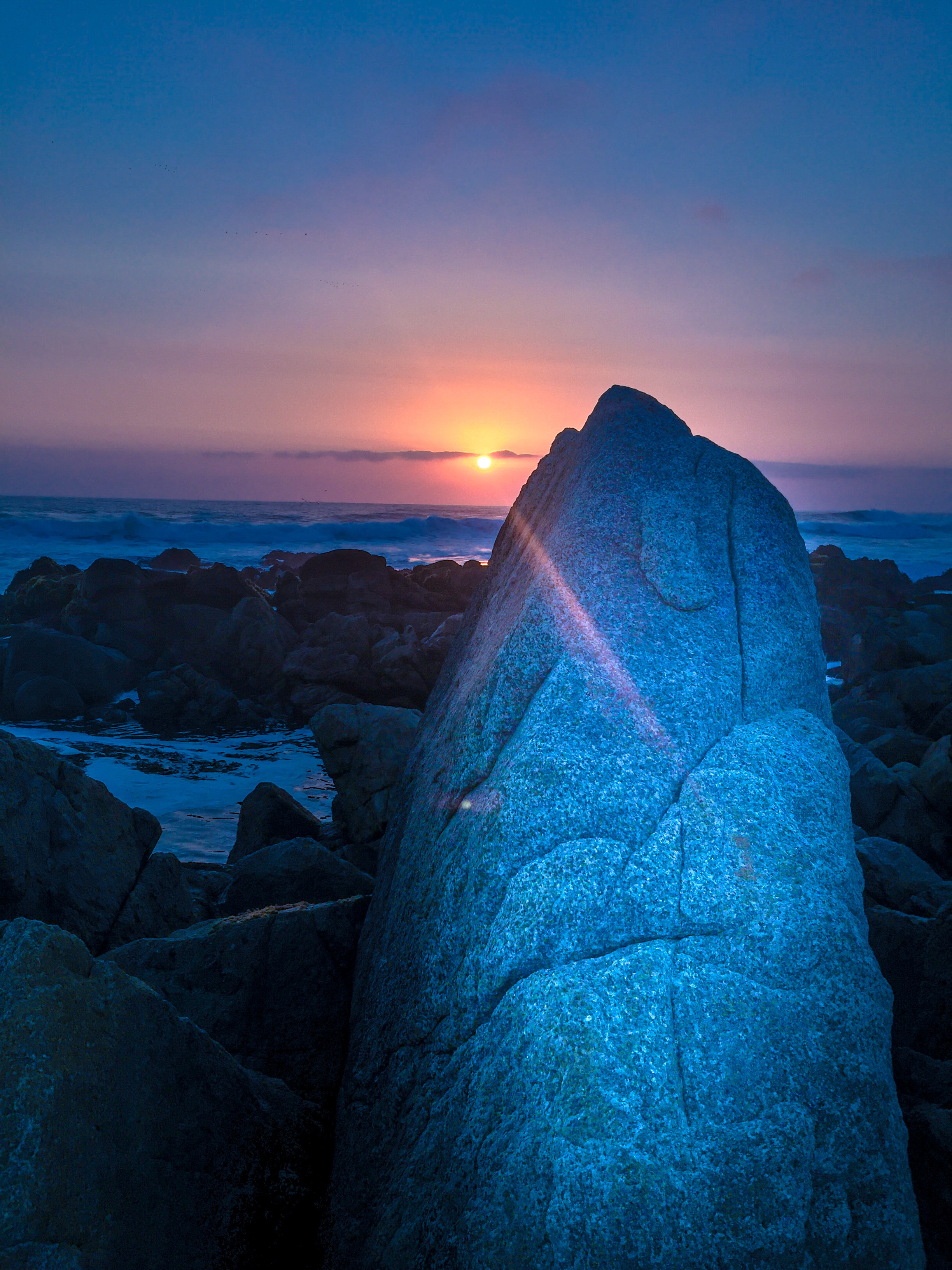 Download mobile wallpaper Rocks, Beams, Rays, Dusk, Sea, Twilight, Sunset, Nature for free.