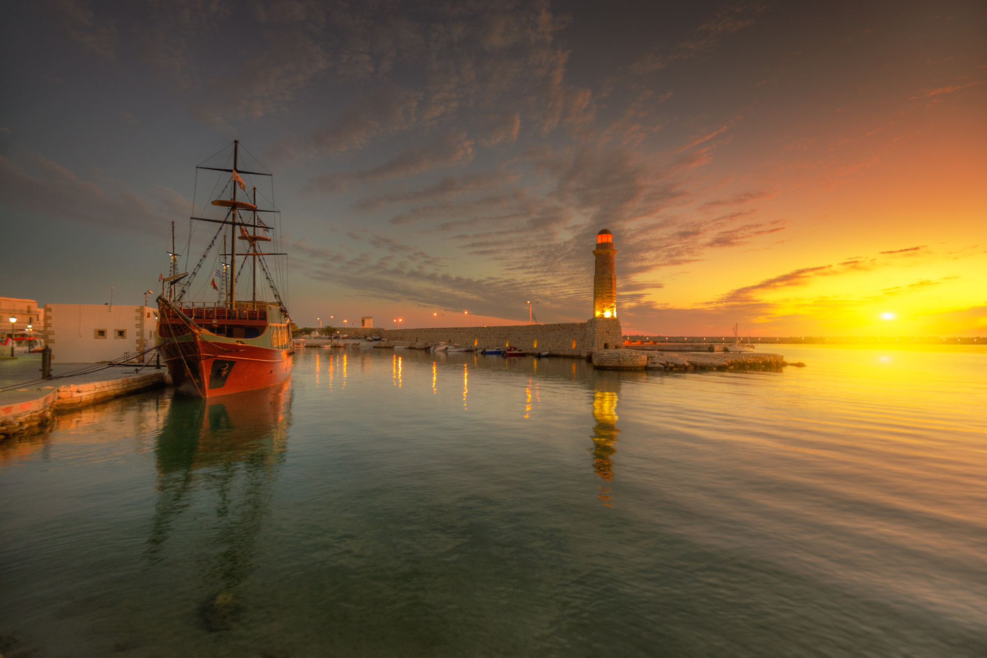 Download mobile wallpaper Sunset, Sea, Building, Ocean, Lighthouse, Ship, Man Made for free.