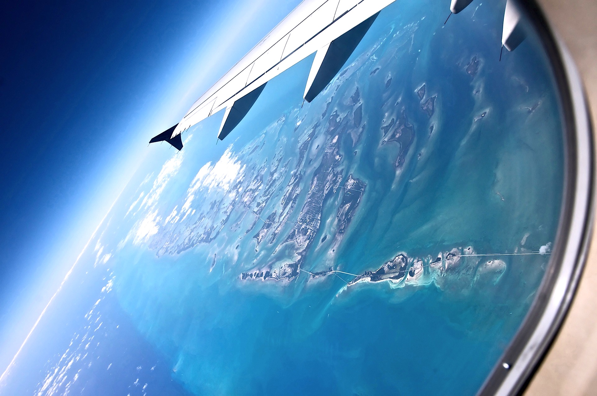 Download mobile wallpaper Island, Airplane, Water, Ocean, Earth for free.