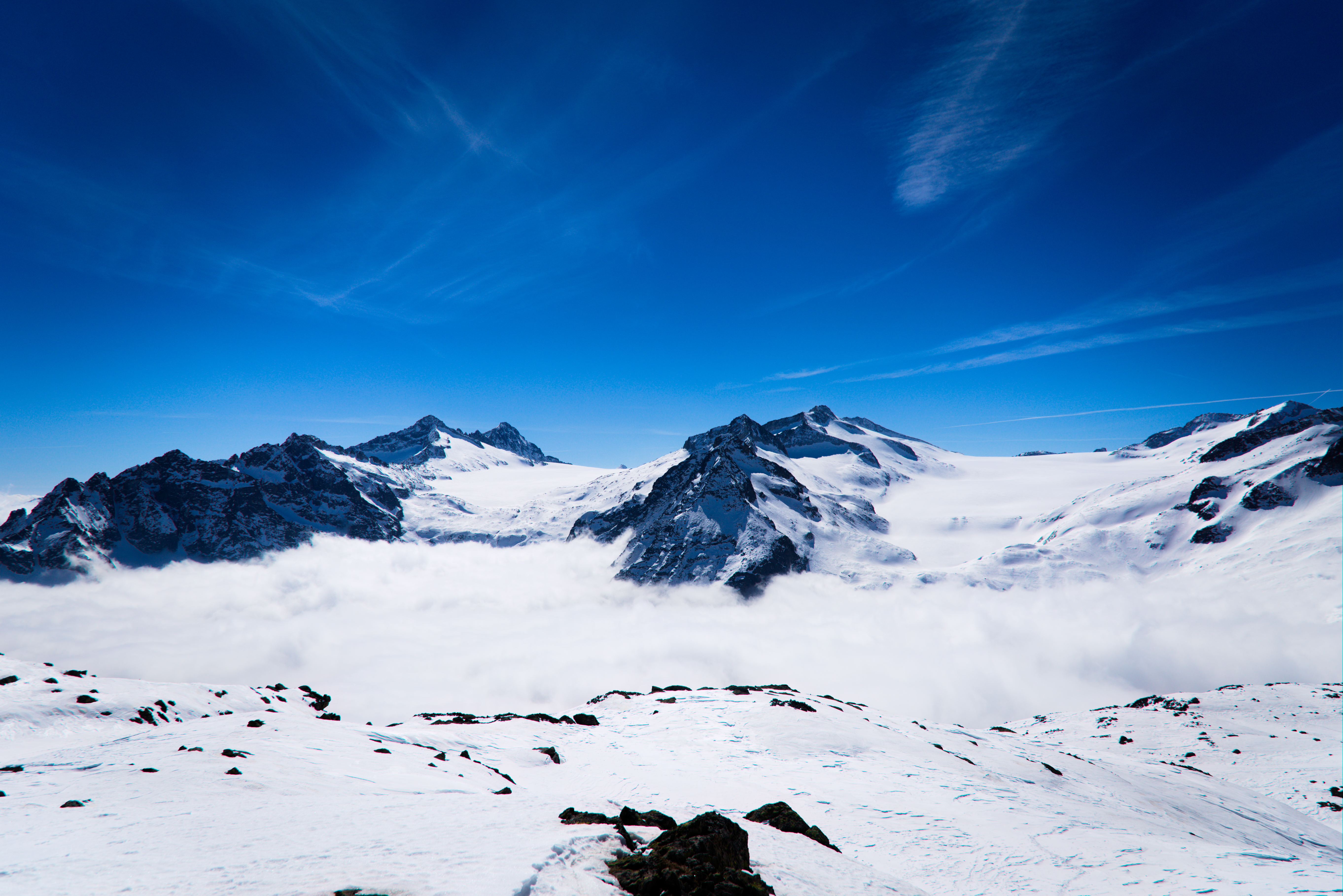 Download mobile wallpaper Clouds, Snowbound, Snow Covered, Mountains, Snow, Nature for free.