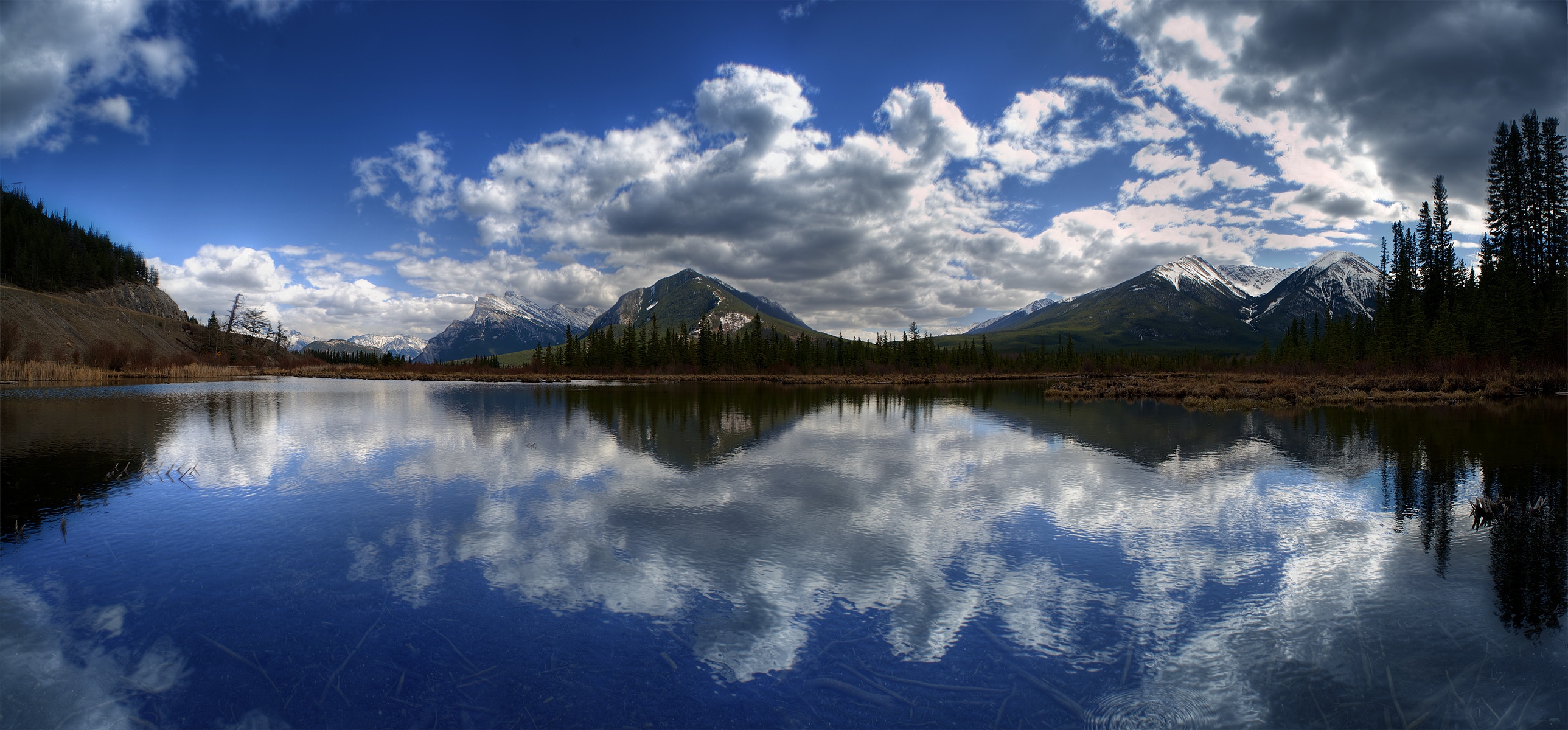 Download mobile wallpaper Reflection, Clouds, Mountains, Lake, Nature, Surface, Panorama for free.