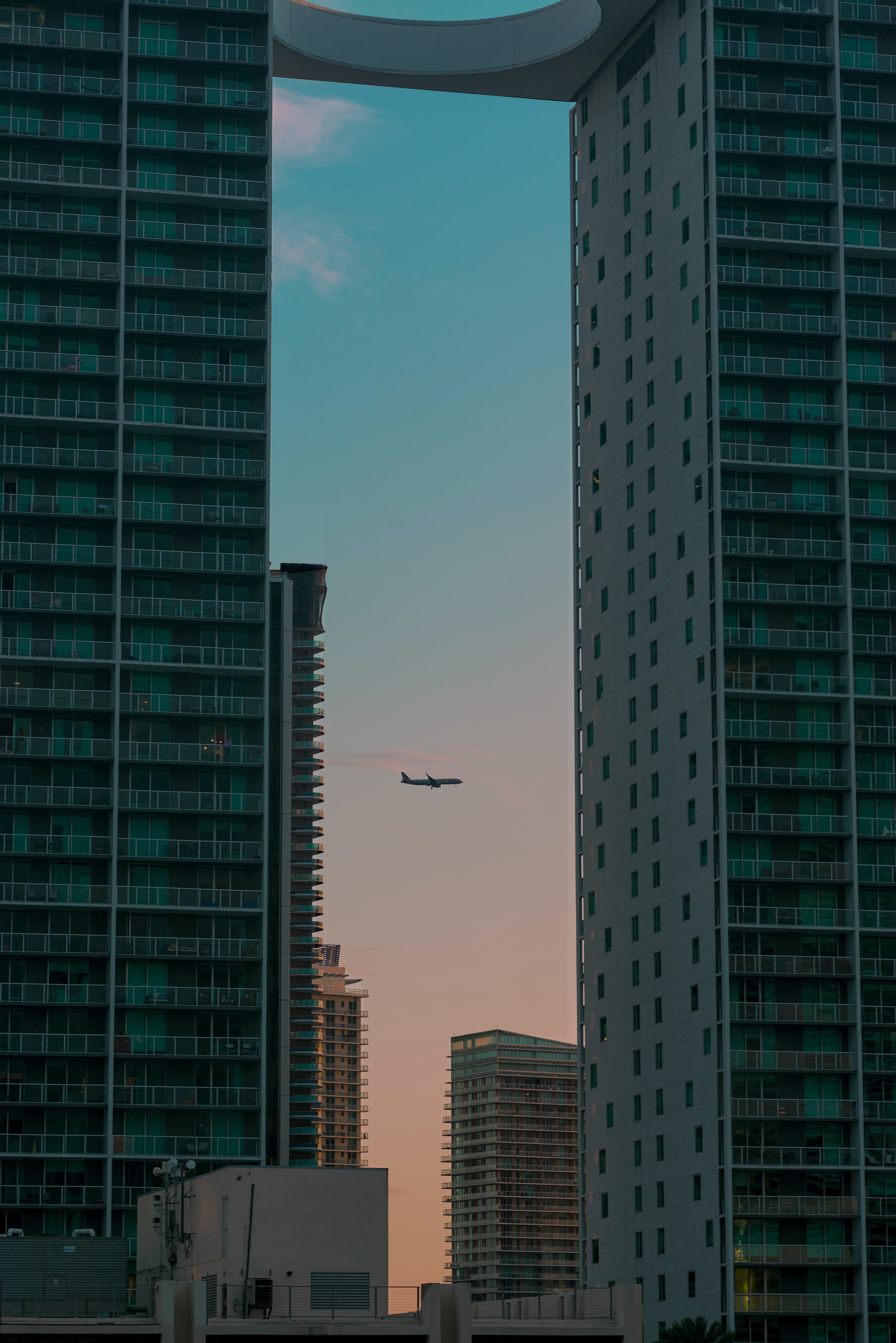 Free download wallpaper Building, Skyscrapers, Evening, Cities, Airplane, Plane on your PC desktop