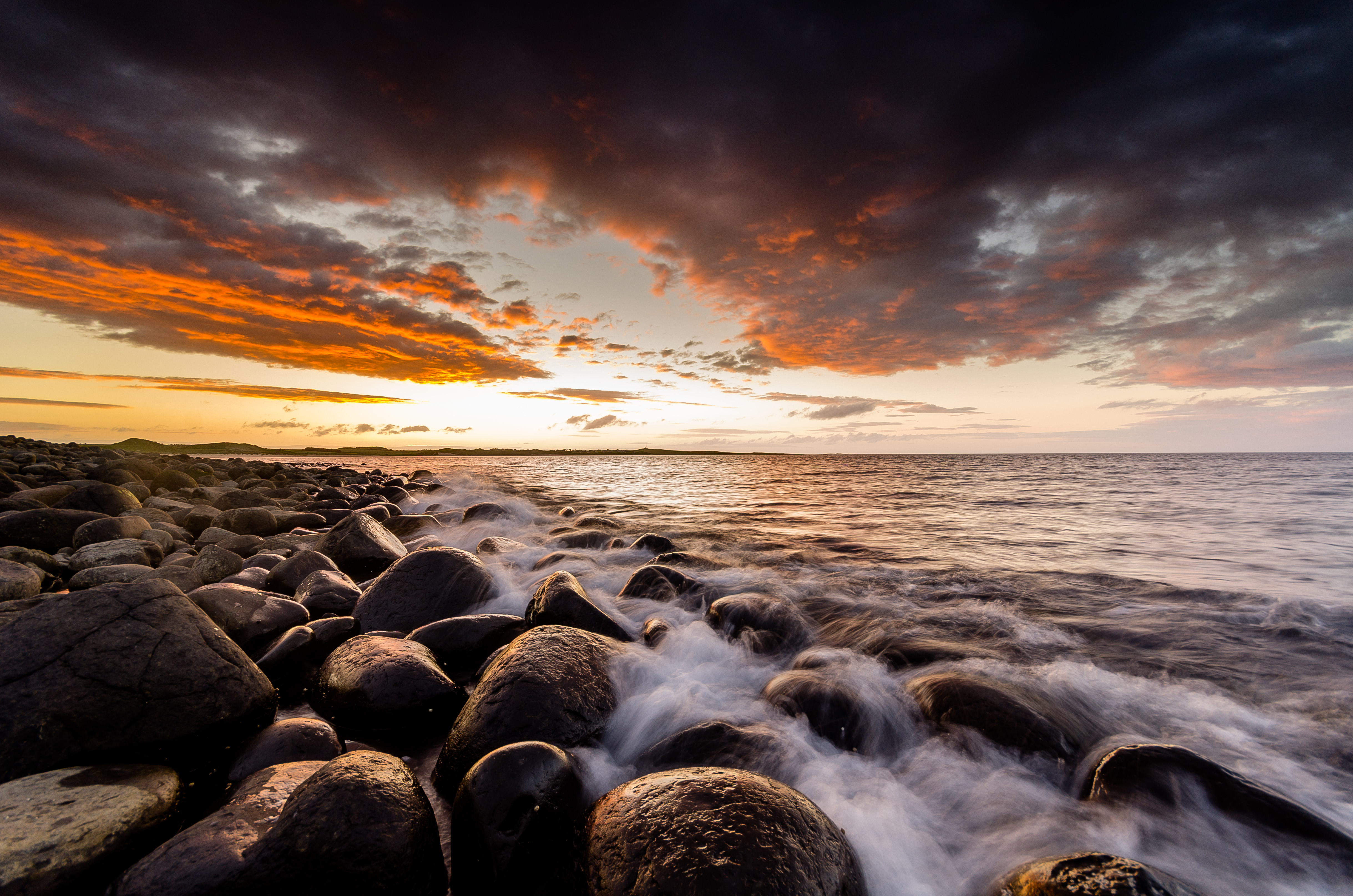 Download mobile wallpaper Horizon, Stones, Waves, Sunset, Nature for free.