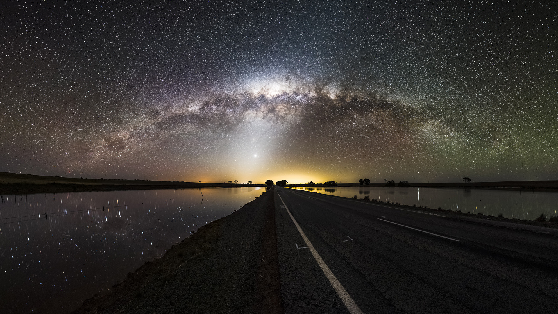 Download mobile wallpaper Water, Sky, Stars, Night, Horizon, Reflection, Road, Milky Way, Man Made for free.