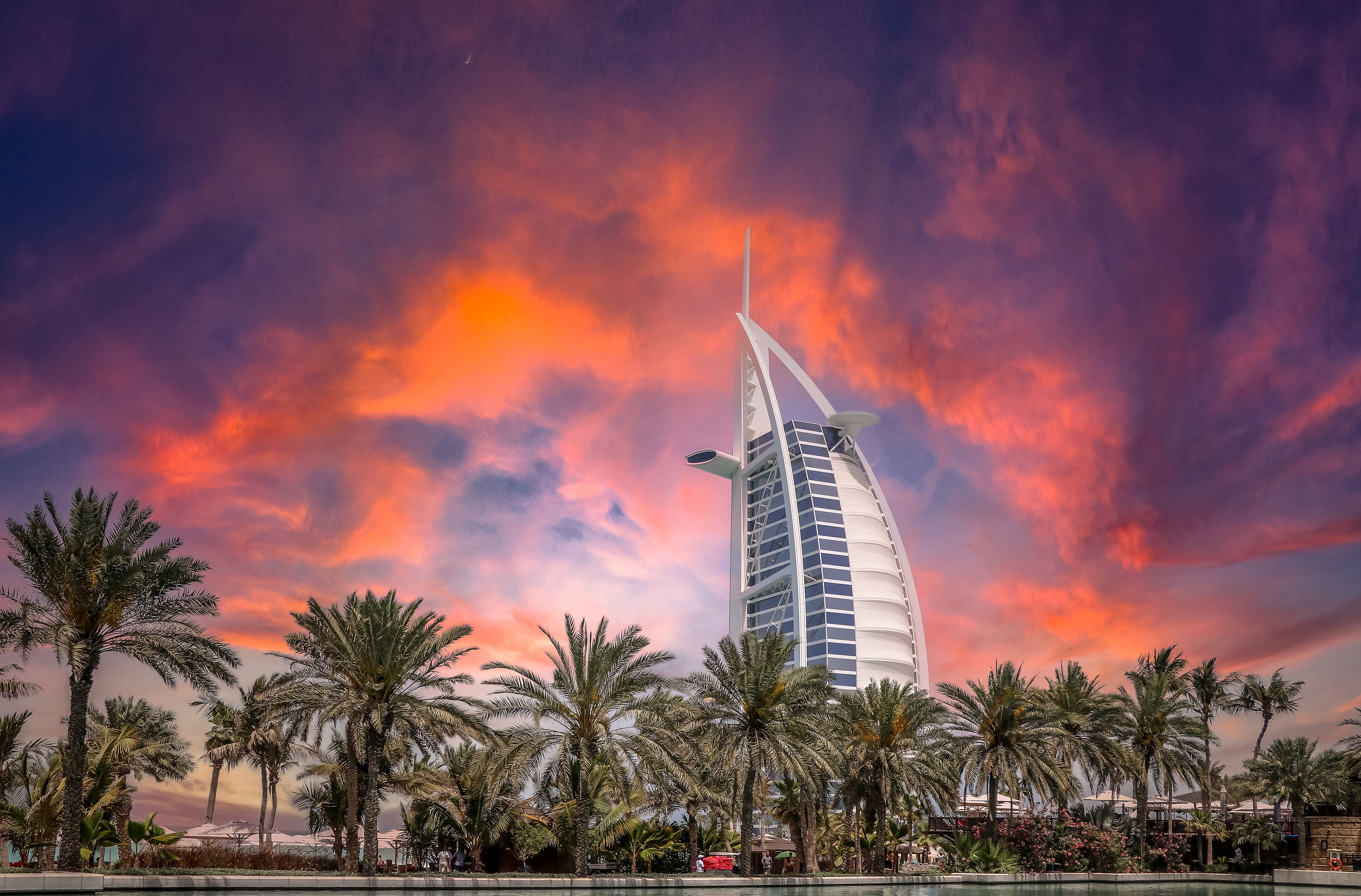 Free download wallpaper Sunset, Sky, Architecture, Skyscraper, Dubai, United Arab Emirates, Burj Al Arab, Man Made, Palm Tree on your PC desktop