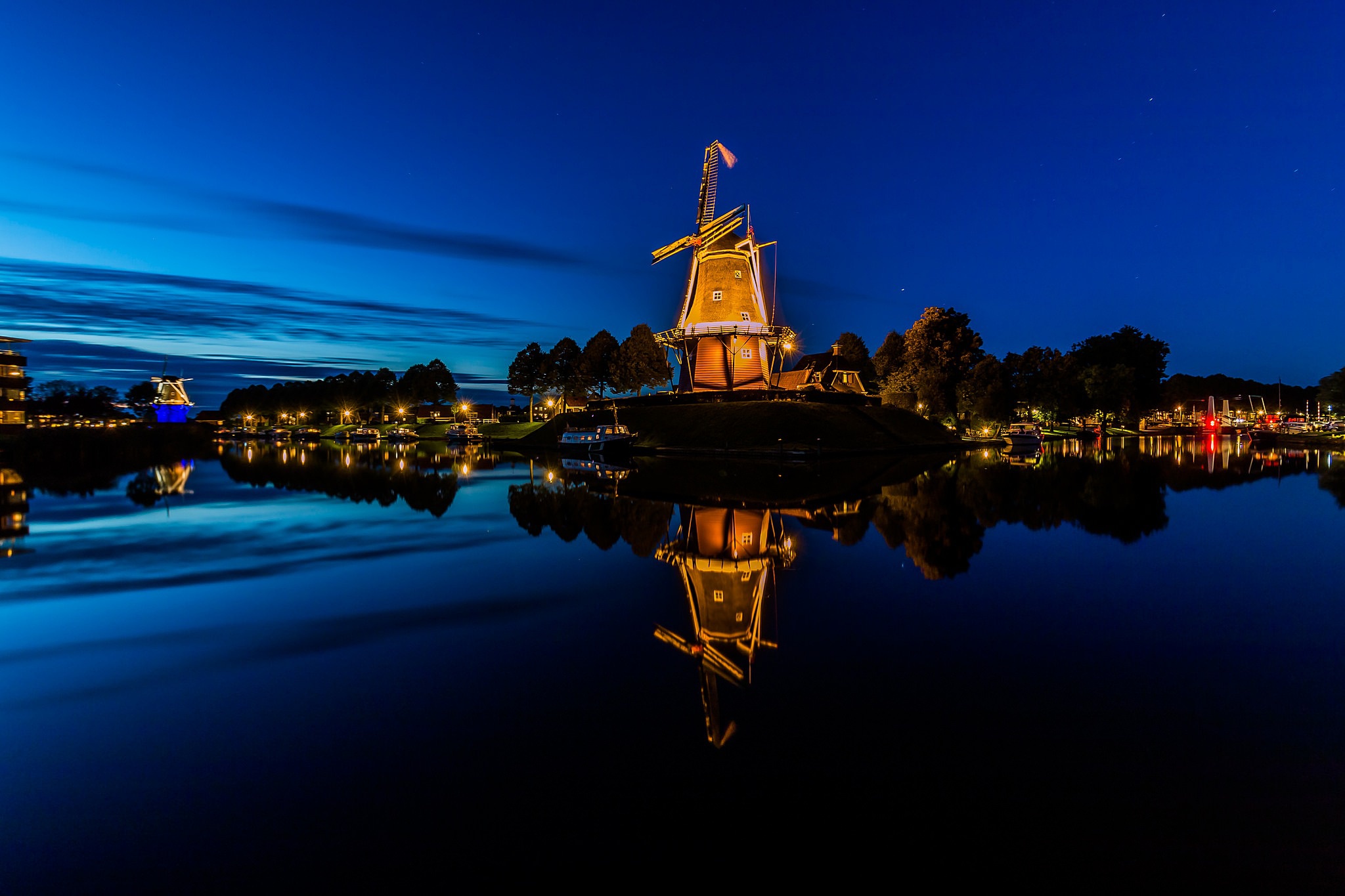 Download mobile wallpaper Night, Building, Reflection, Windmill, Man Made for free.