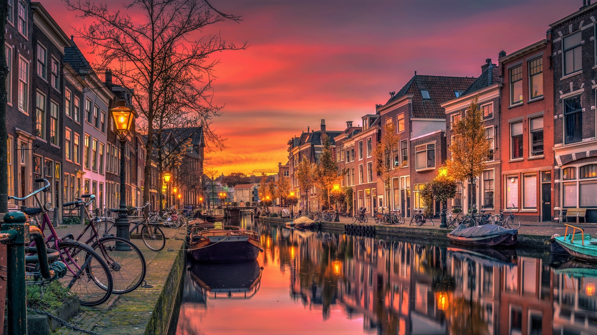 Free download wallpaper Sunset, City, House, Boat, Town, Man Made, Canal, Katwijk, Towns on your PC desktop