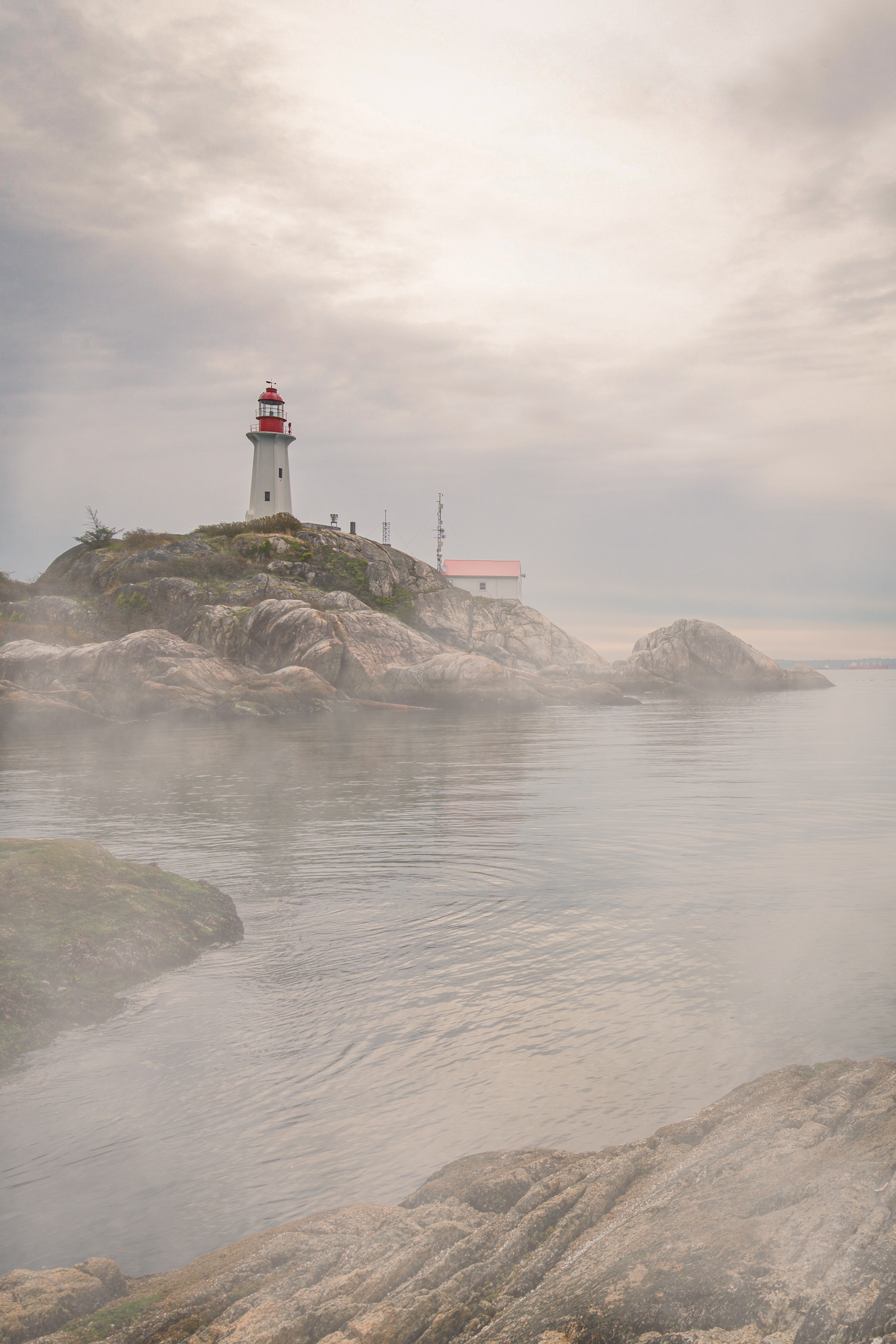 Download mobile wallpaper Fog, Rocks, Coast, Water, Lighthouse, Nature for free.