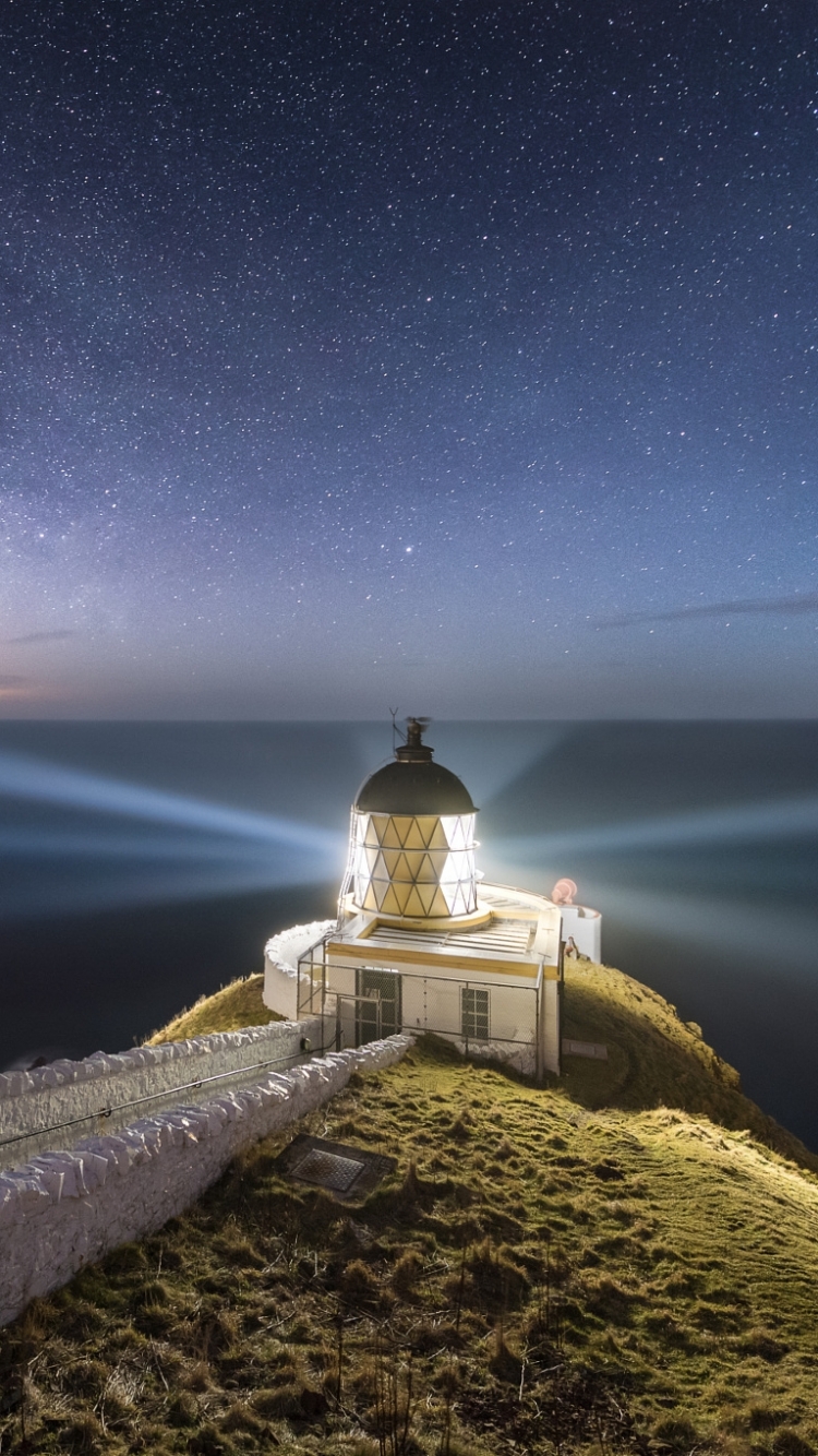 Download mobile wallpaper Sky, Night, Ocean, Starry Sky, Lighthouse, Star, Man Made for free.