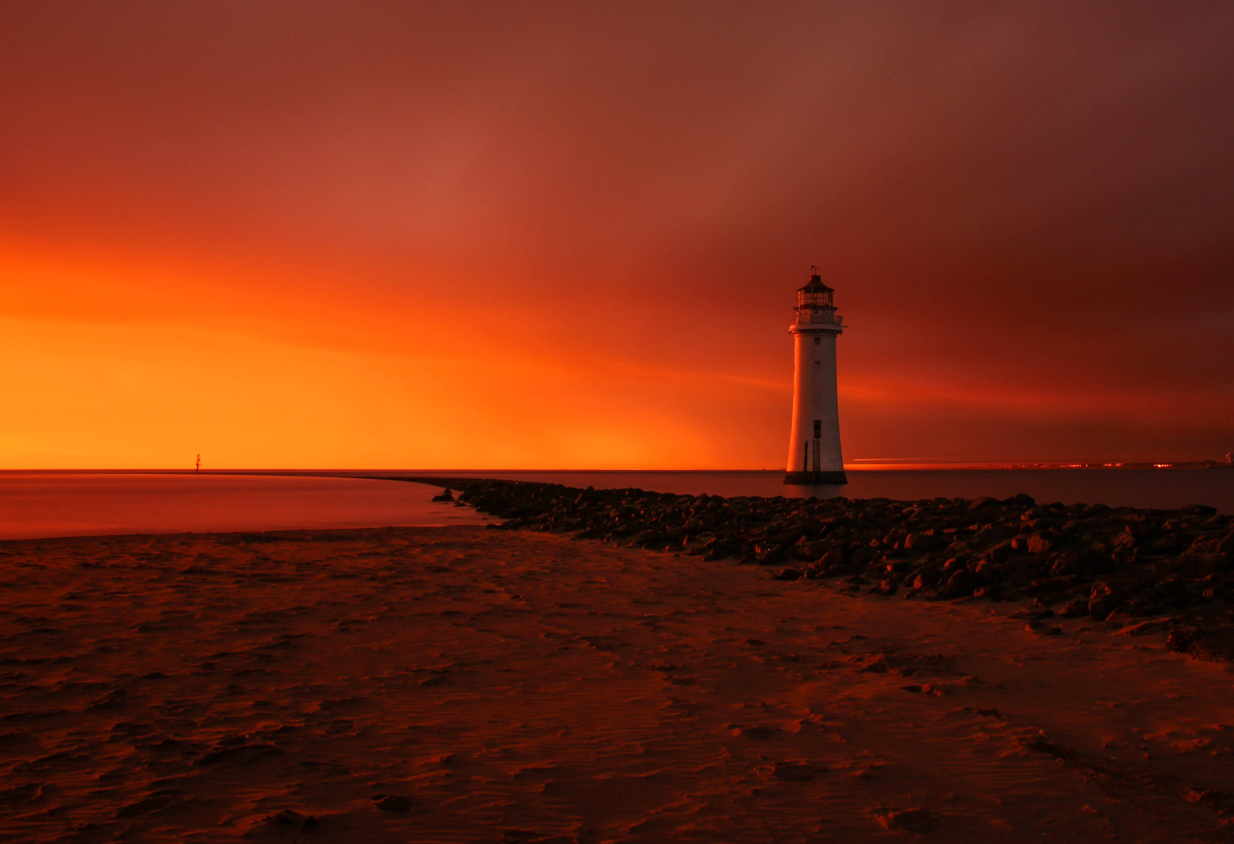 Download mobile wallpaper Sunset, Sky, Horizon, Lighthouse, Man Made, Orange (Color) for free.