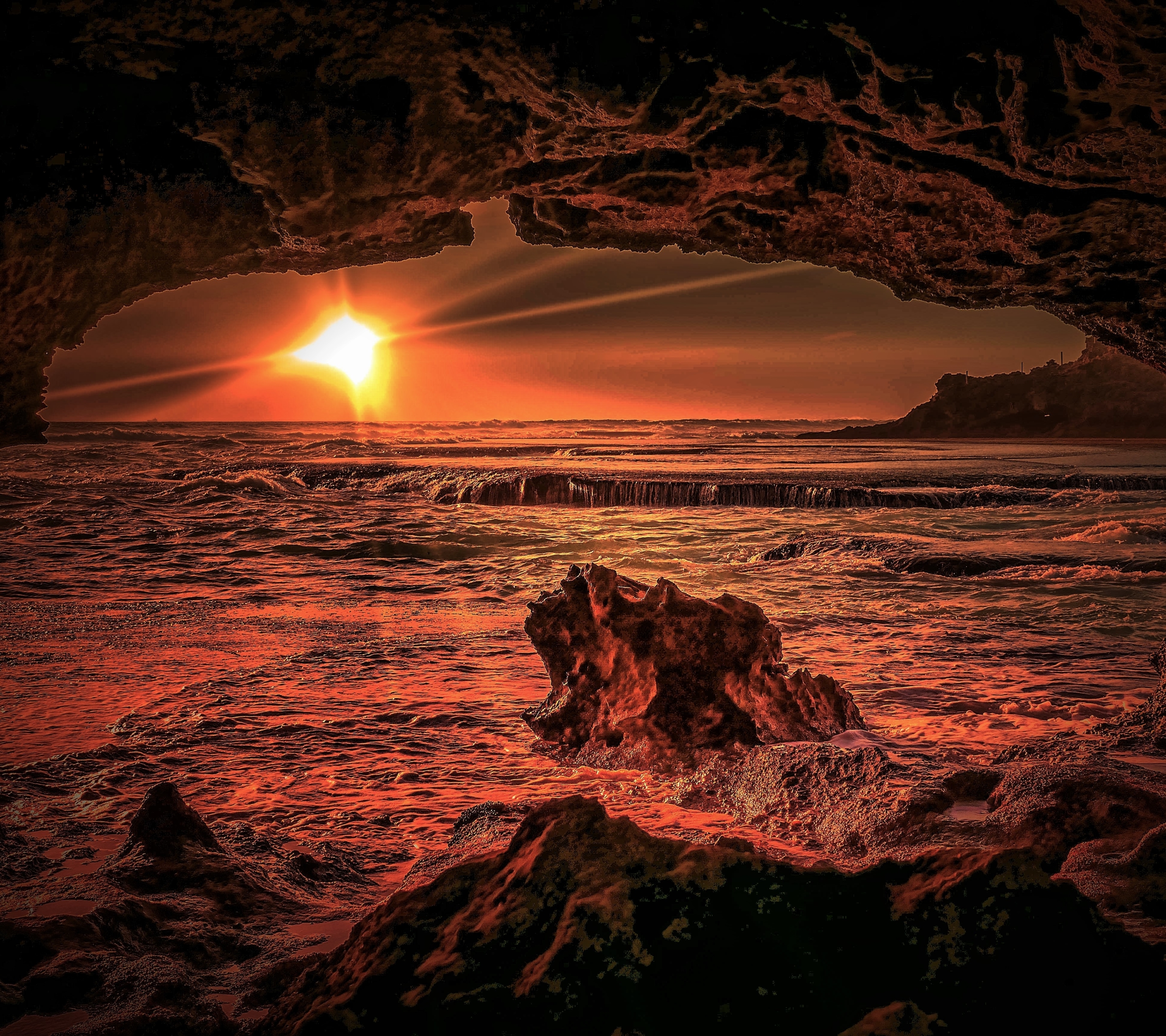 Download mobile wallpaper Sunset, Sea, Sun, Caves, Horizon, Ocean, Earth, Cave for free.