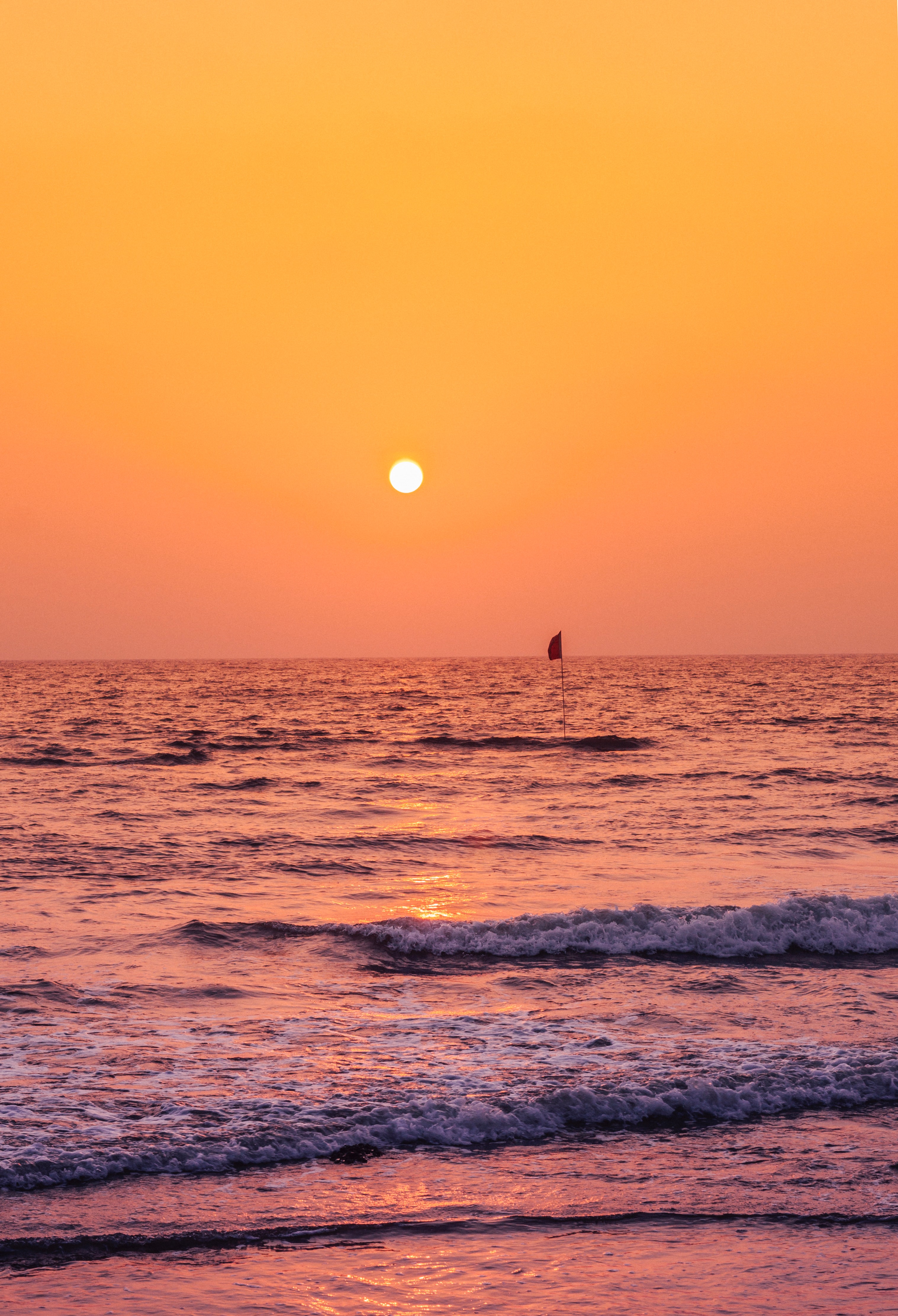 Free download wallpaper Nature, Sunset, Sun, Sea, Waves, Flag on your PC desktop