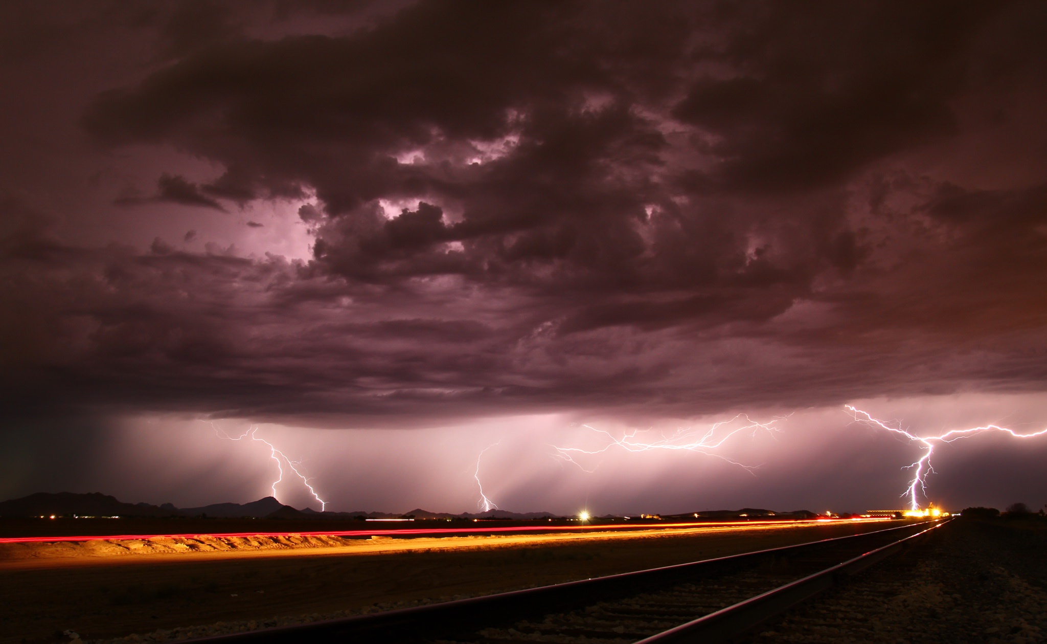 Download mobile wallpaper Night, Lightning, Storm, Cloud, Photography, Railroad for free.