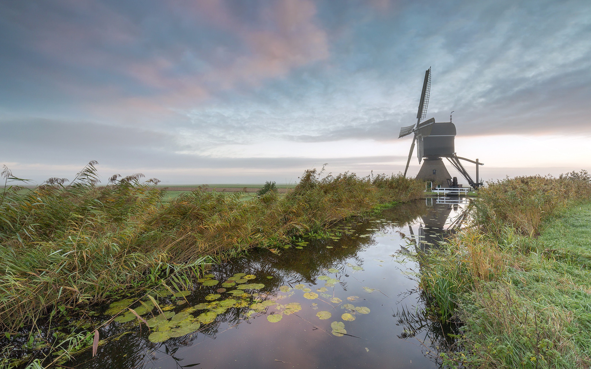 Free download wallpaper Landscape, Sky, Building, Reflection, Plant, Cloud, River, Windmill, Man Made on your PC desktop