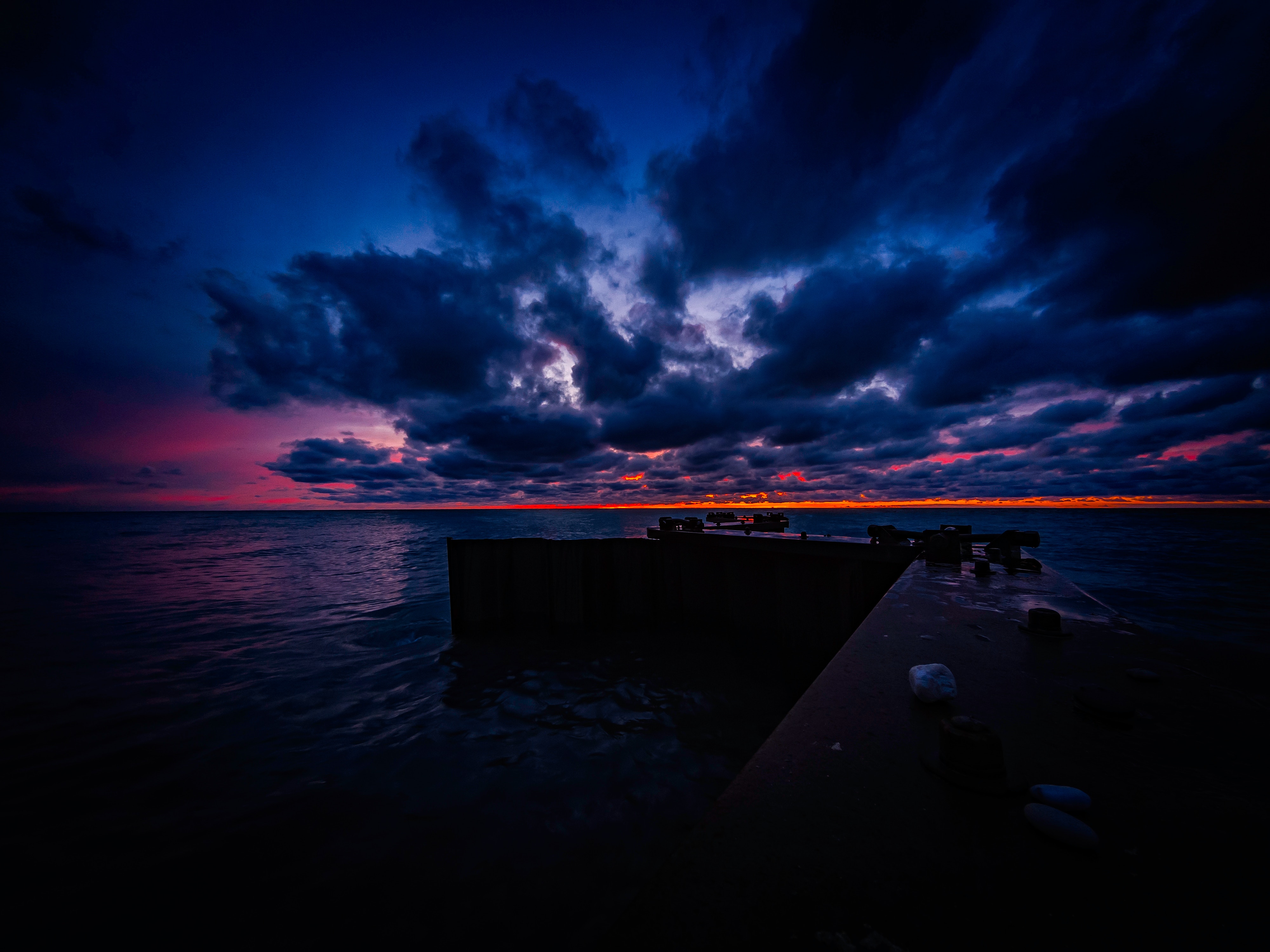 Download mobile wallpaper Clouds, Horizon, Sunset, Pier, Ocean, Dark for free.