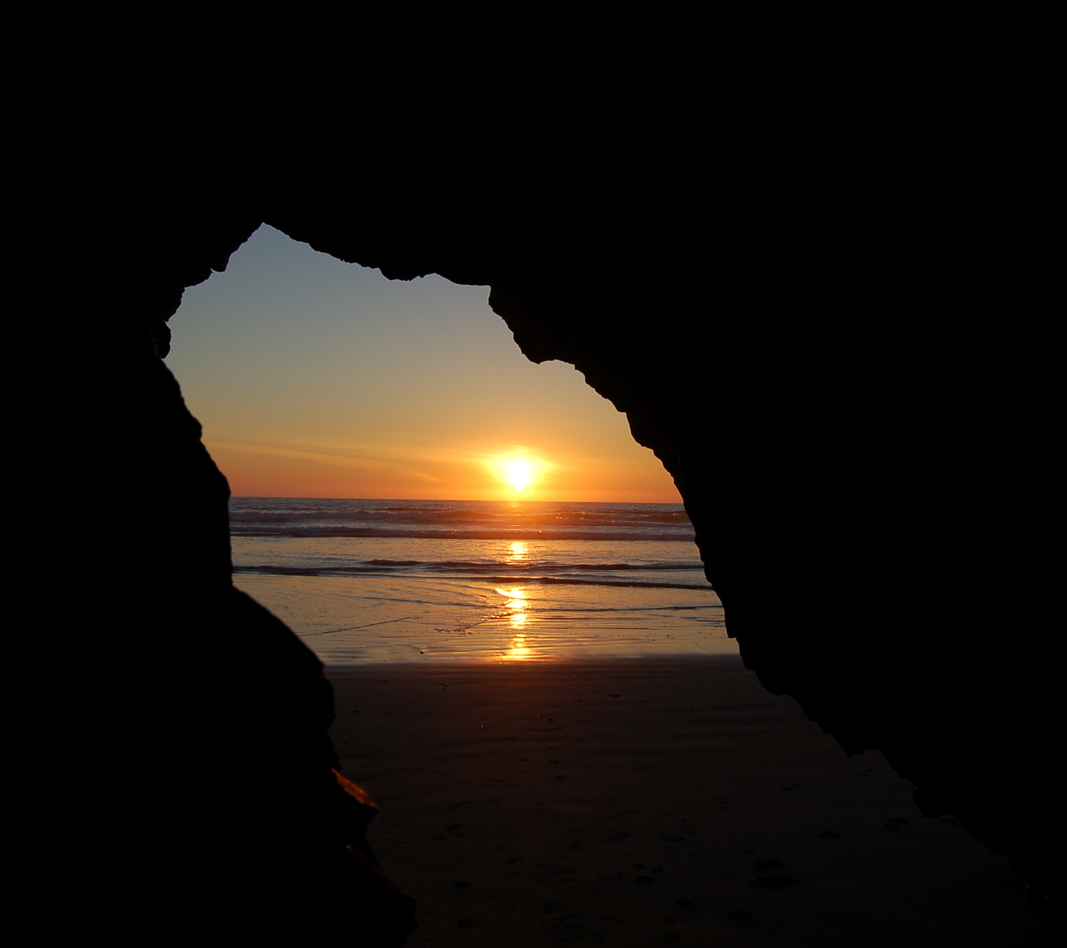 Download mobile wallpaper Cave, Beach, Ocean, Earth, Sunset for free.