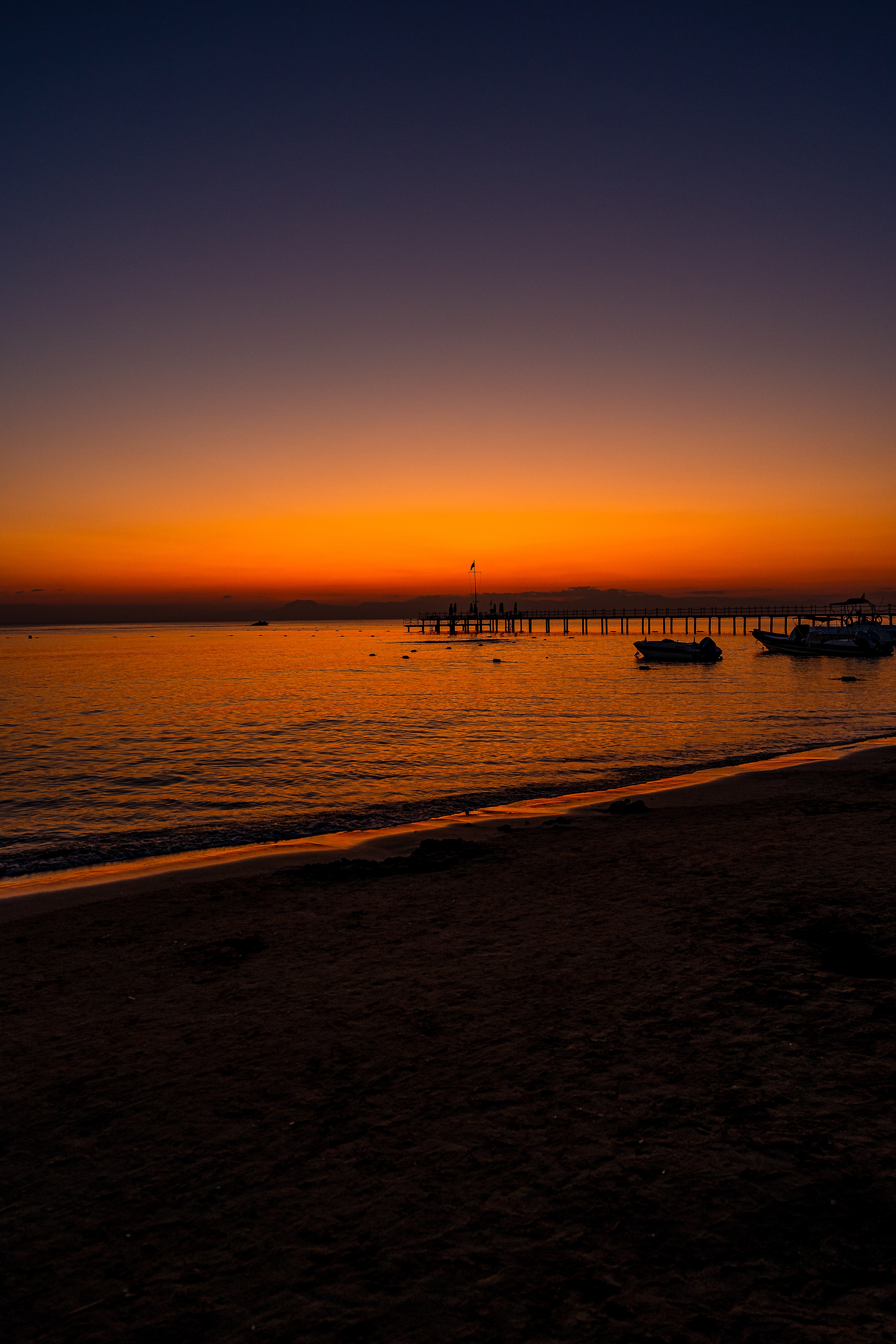 dark, pier, sunset, twilight, beach, boats, dusk phone wallpaper