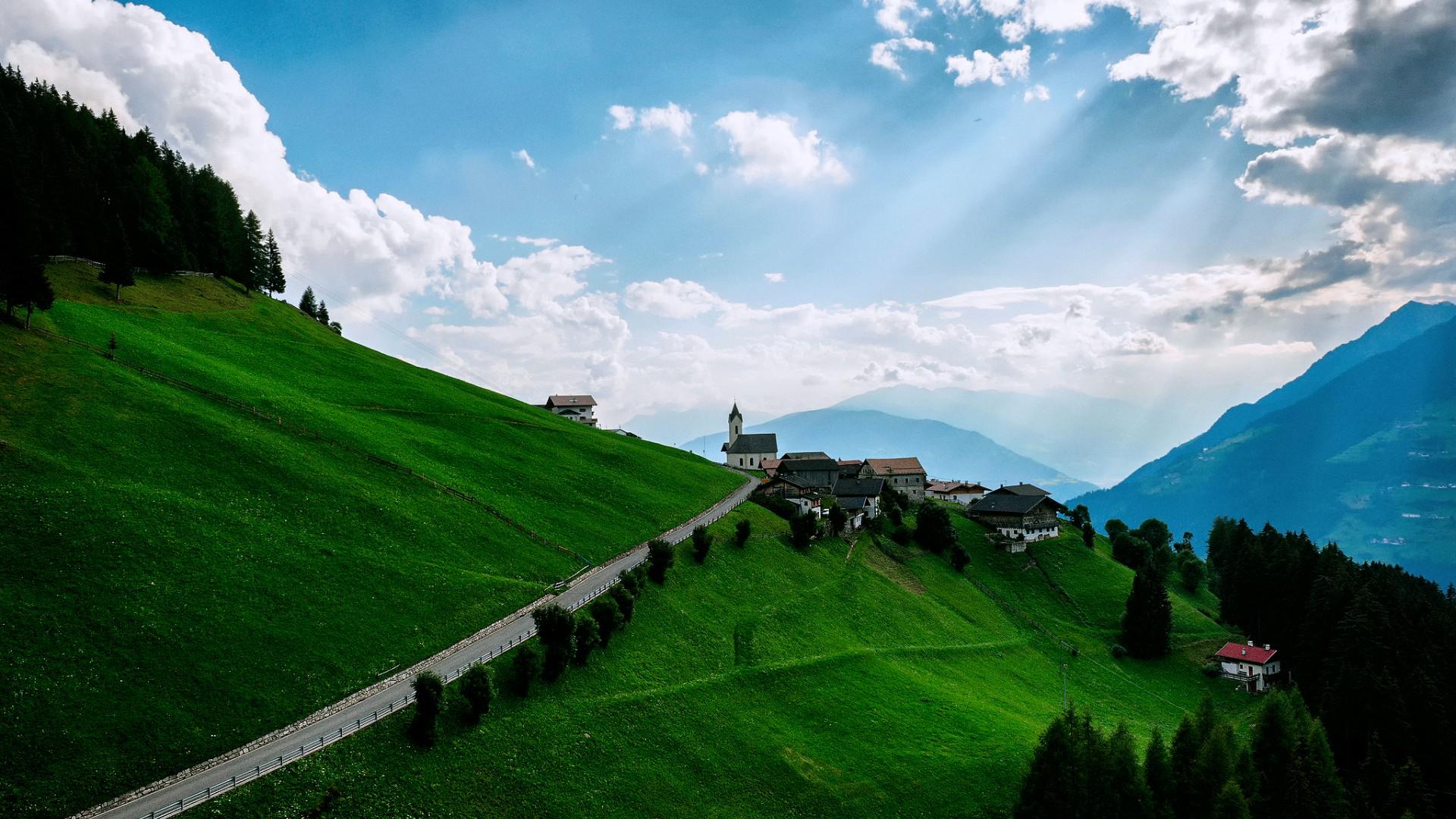 Download mobile wallpaper Landscape, Mountain, Tree, Village, Cloud, Man Made, Sunshine for free.
