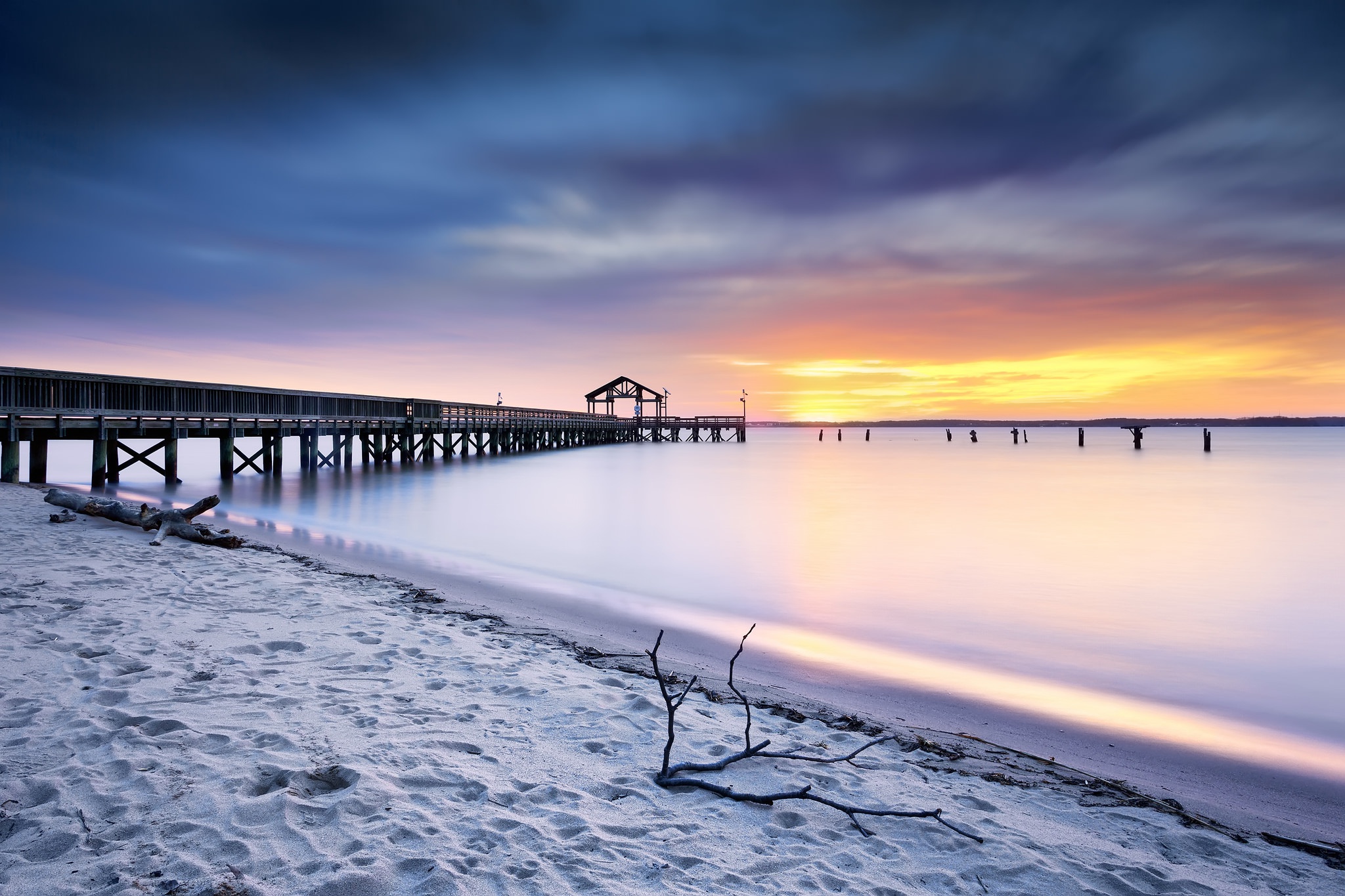 Download mobile wallpaper Sunset, Sky, Sand, Horizon, Pier, Ocean, Man Made for free.
