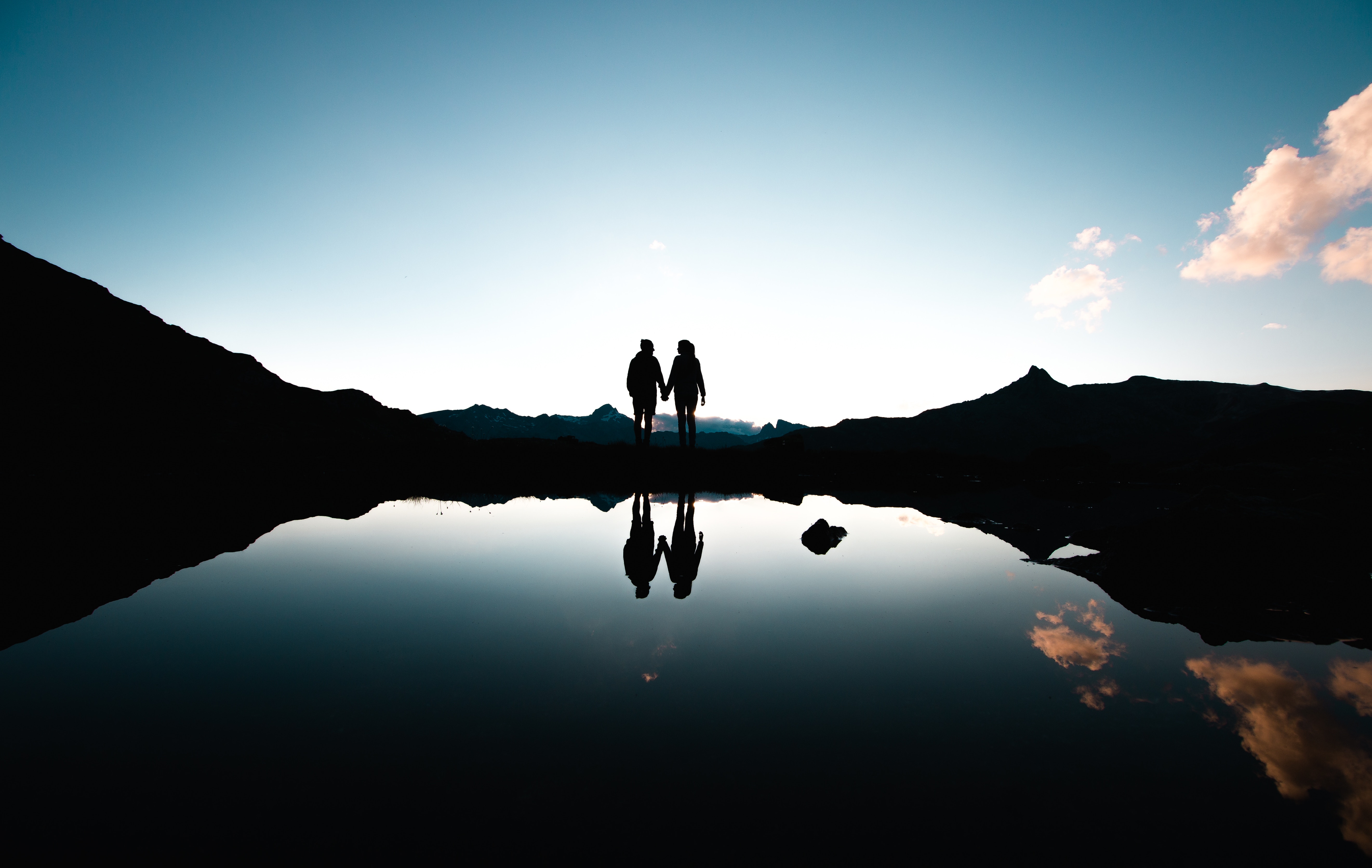 Download mobile wallpaper Reflection, Sunset, Silhouettes, Pair, Dark, Couple for free.