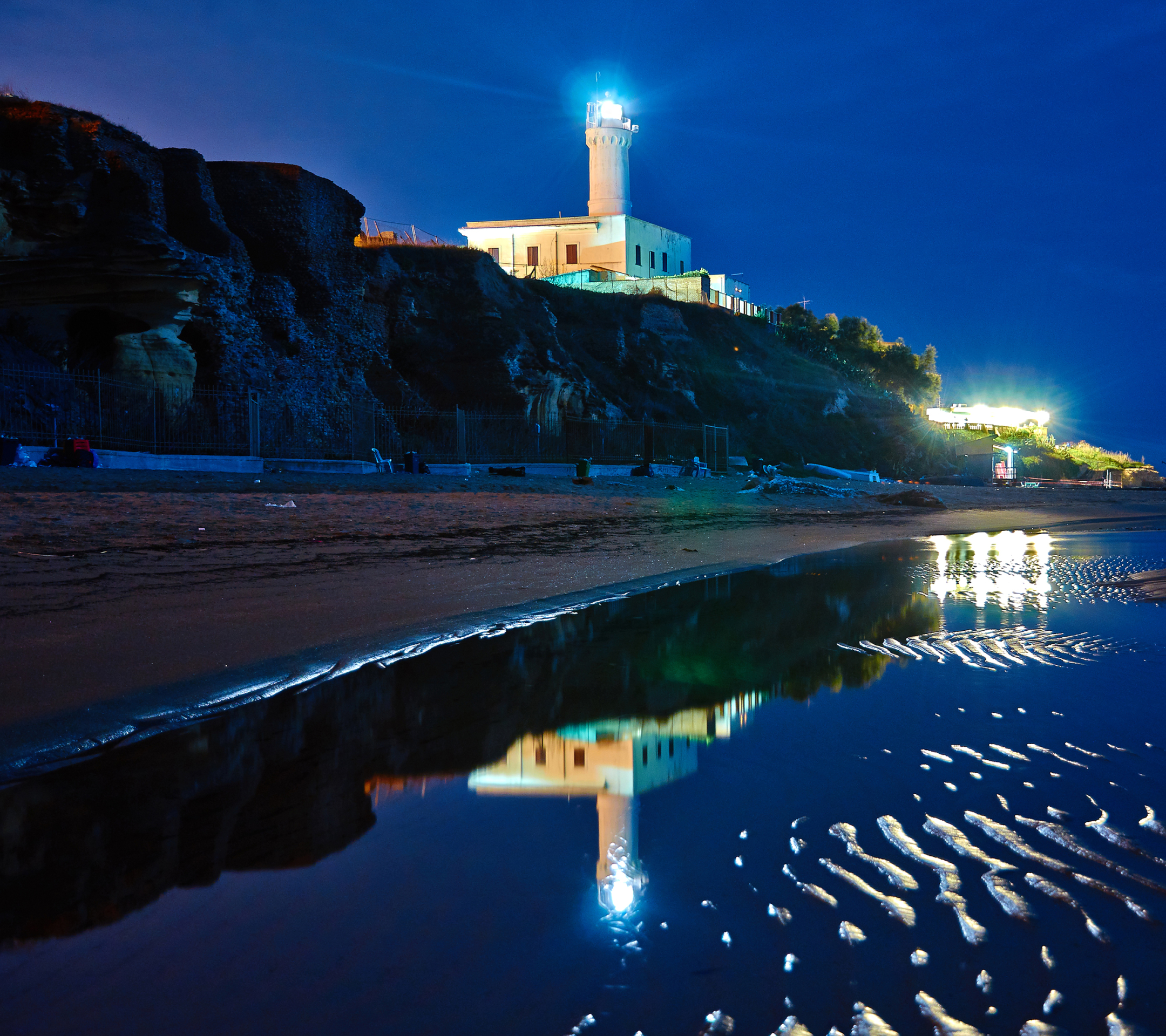 Download mobile wallpaper Sea, Night, Italy, Coast, Ocean, Lighthouse, Man Made for free.