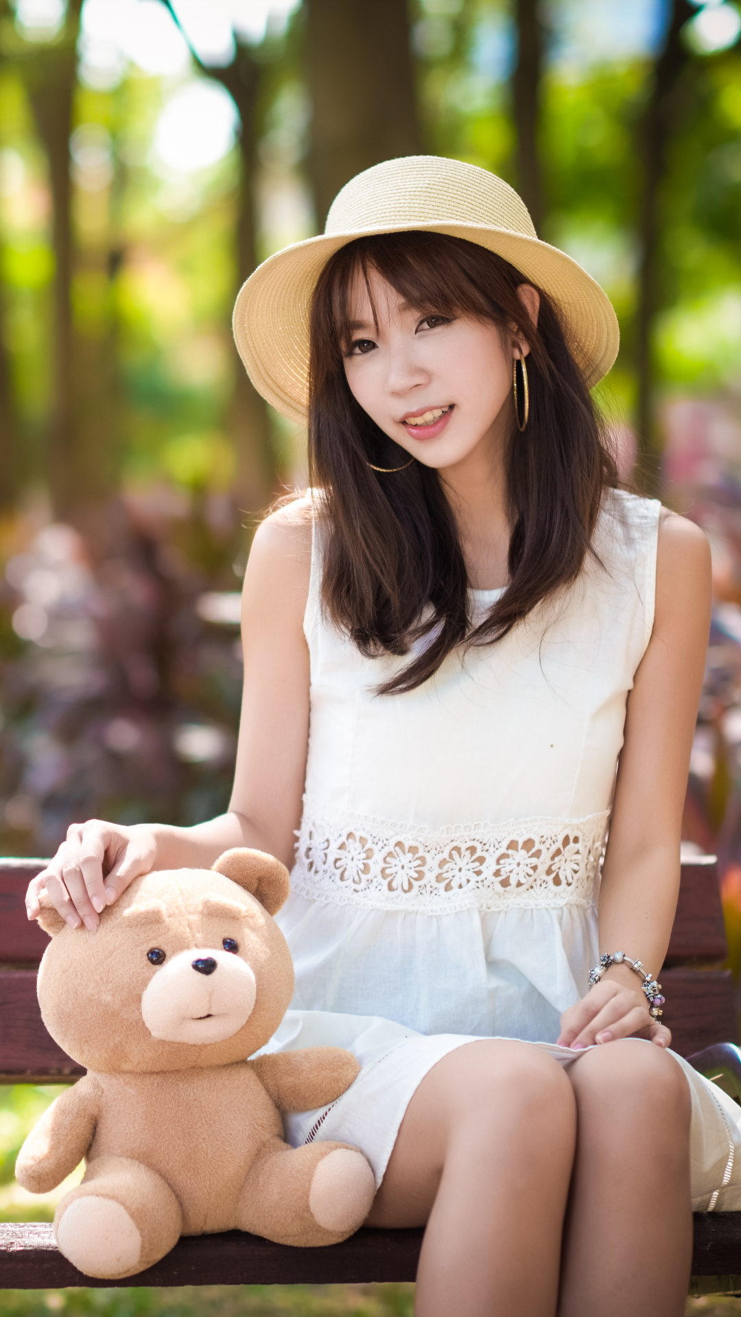 Download mobile wallpaper Teddy Bear, Smile, Hat, Brunette, Model, Women, Earrings, Asian, Brown Eyes, Depth Of Field for free.