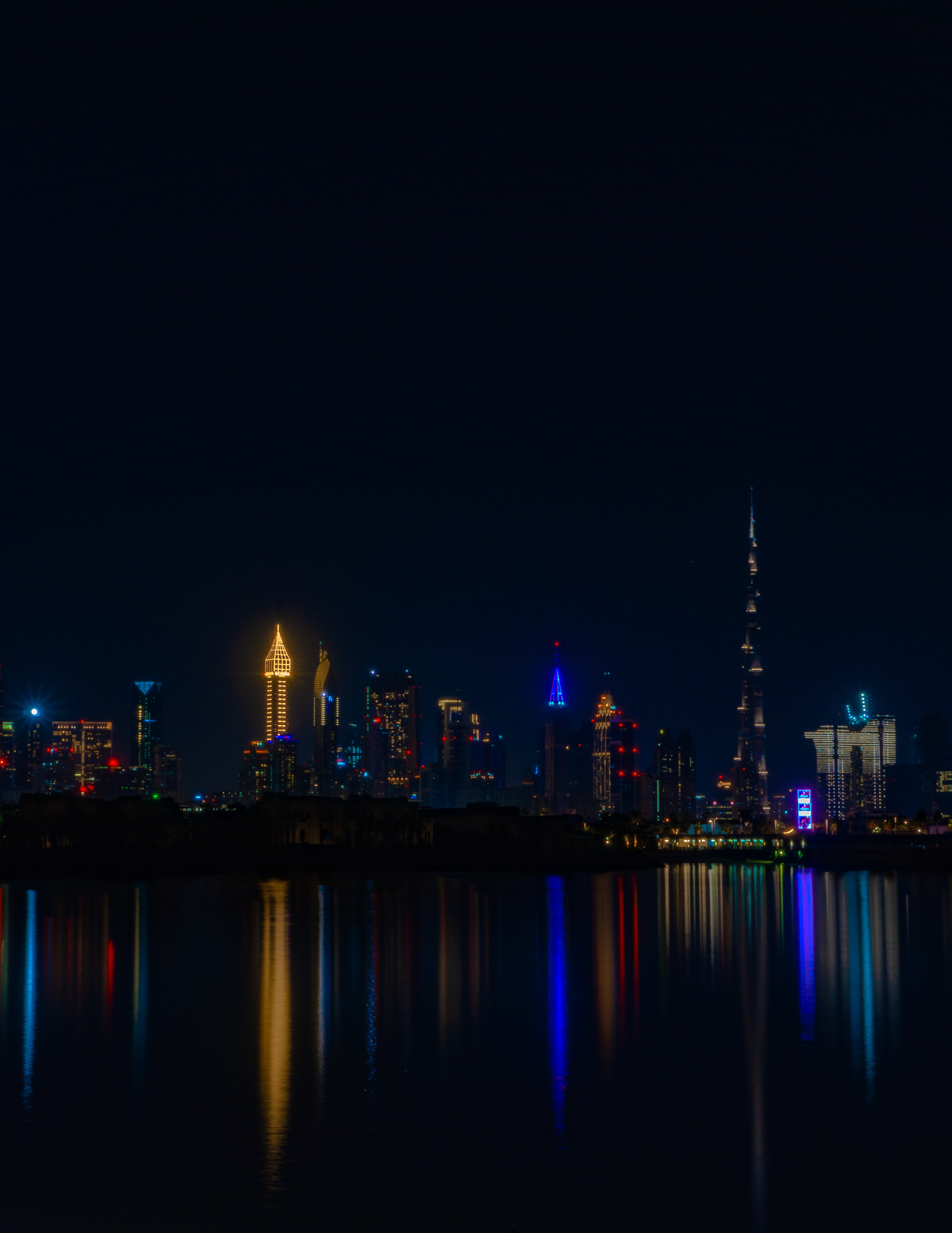 Download mobile wallpaper Reflection, City, Cities, Coast, Building, Water, Night, Dark for free.