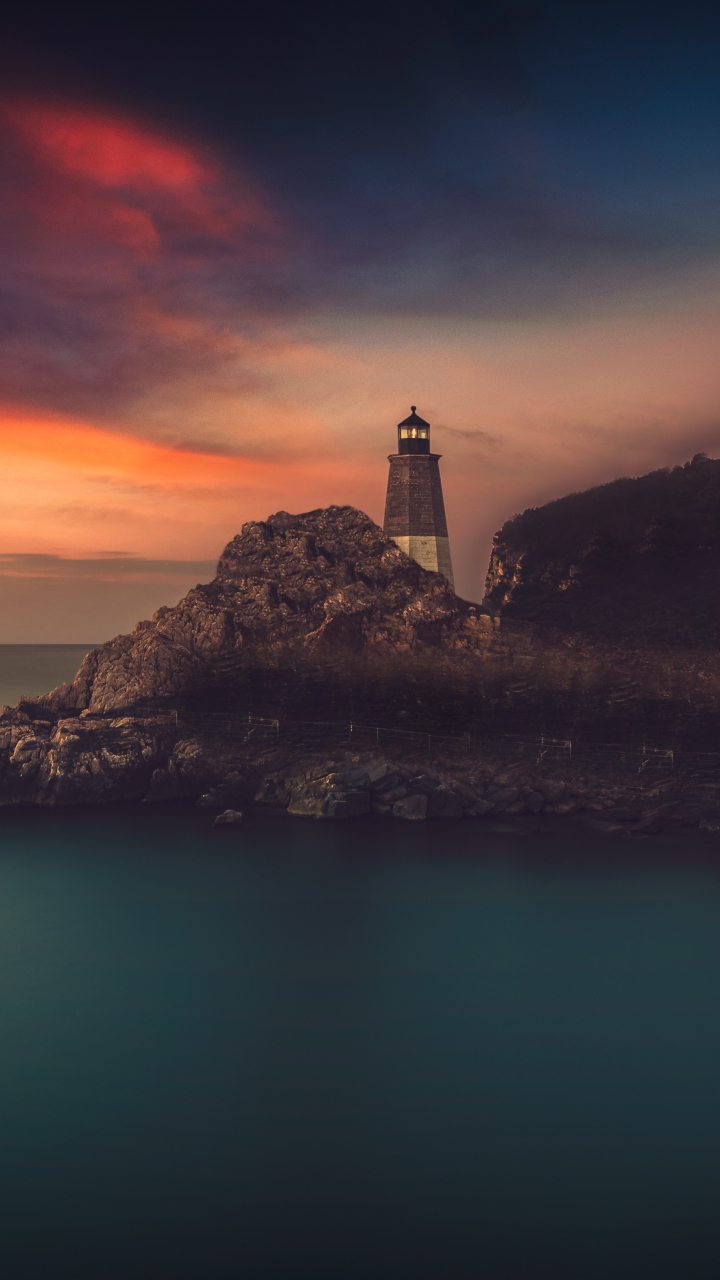 Download mobile wallpaper Sunset, Sky, Horizon, Coast, Ocean, Lighthouse, Man Made for free.