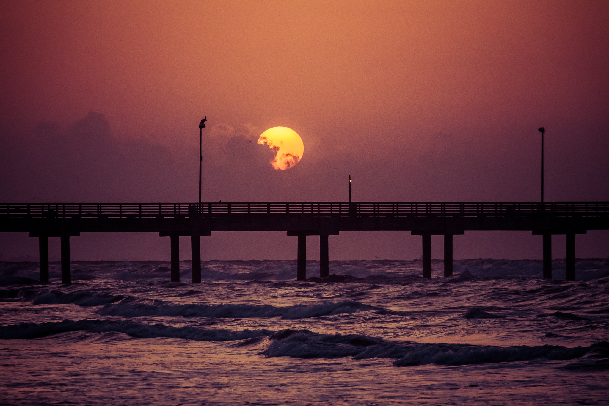 Download mobile wallpaper Sunset, Sky, Sea, Sun, Pier, Ocean, Earth, Purple, Orange (Color) for free.