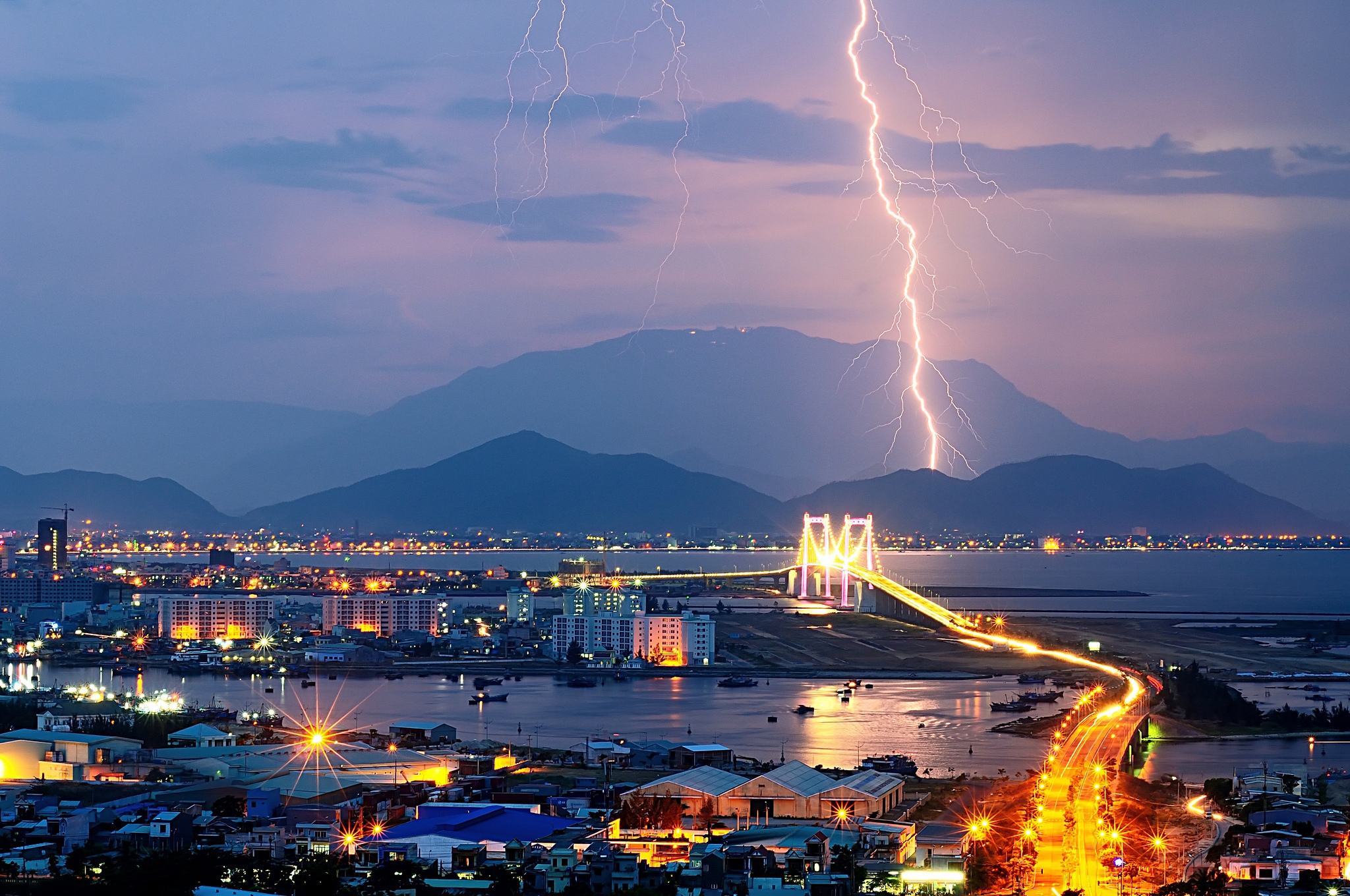 Download mobile wallpaper Lights, Cities, City, Evening, Mountains, Lightning for free.