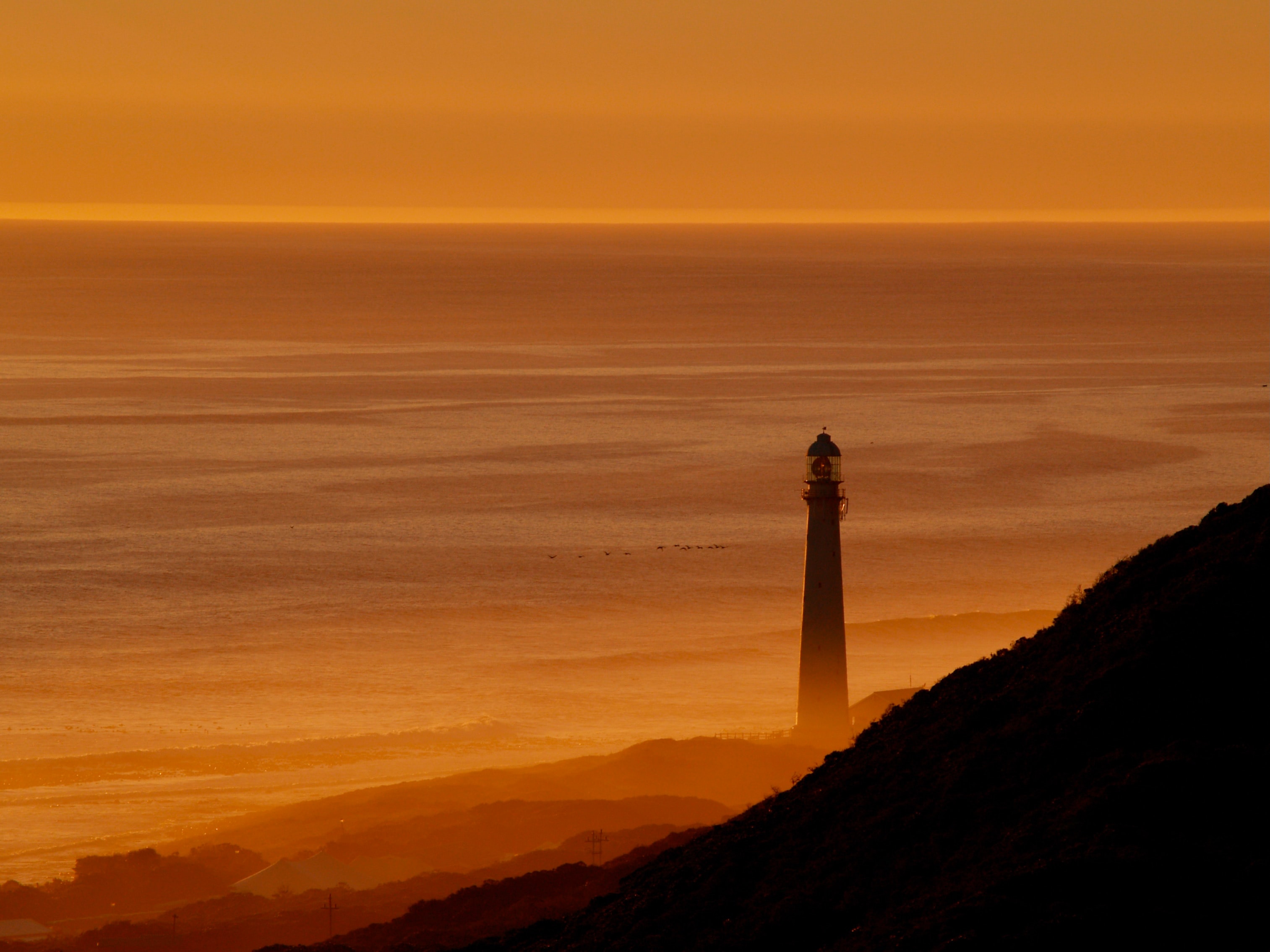 Free download wallpaper Sunset, Mountains, Sea, Lighthouse, Tower, Dark on your PC desktop