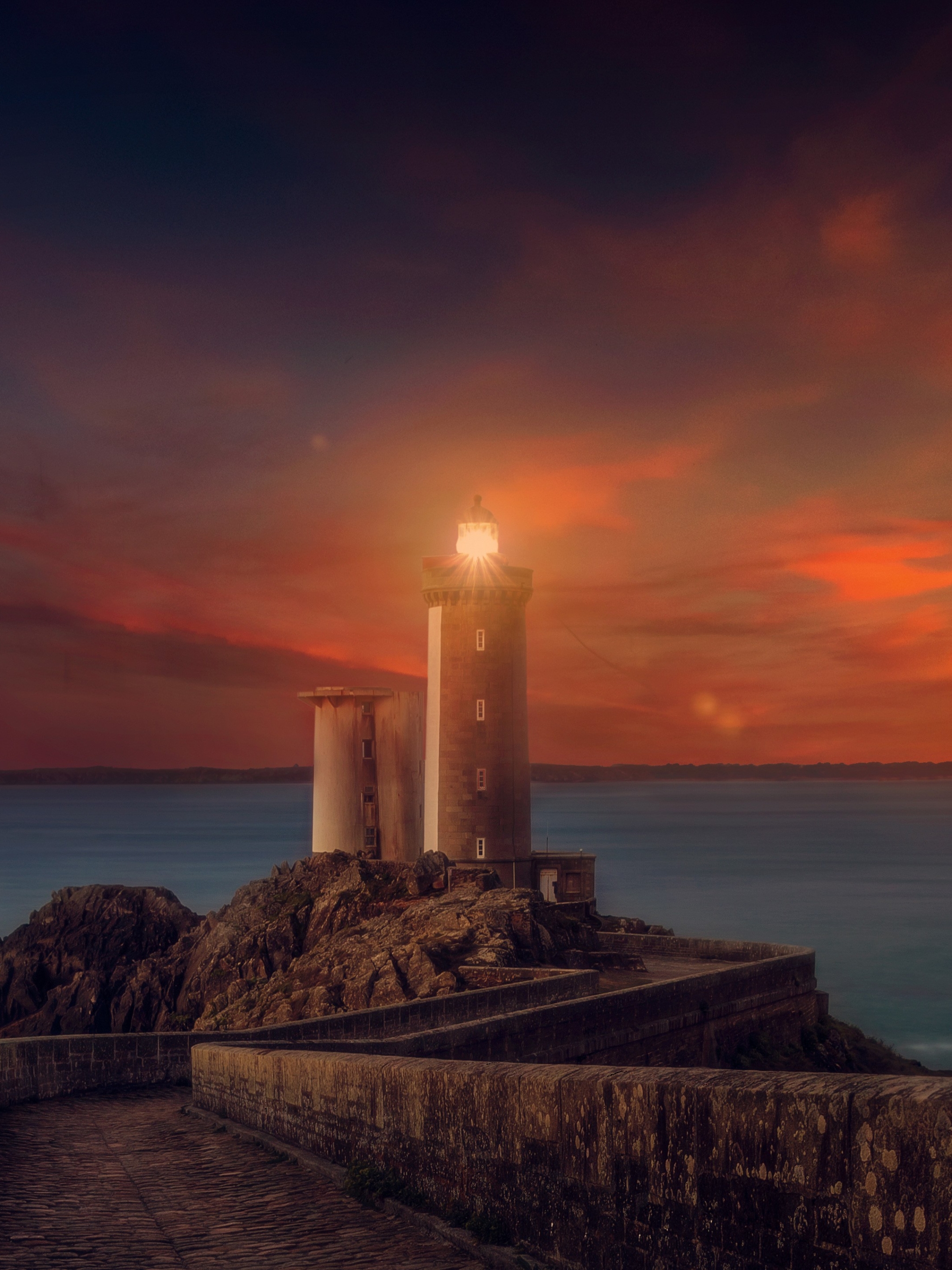 Download mobile wallpaper Sunset, Sky, Lighthouse, Man Made, Orange (Color) for free.