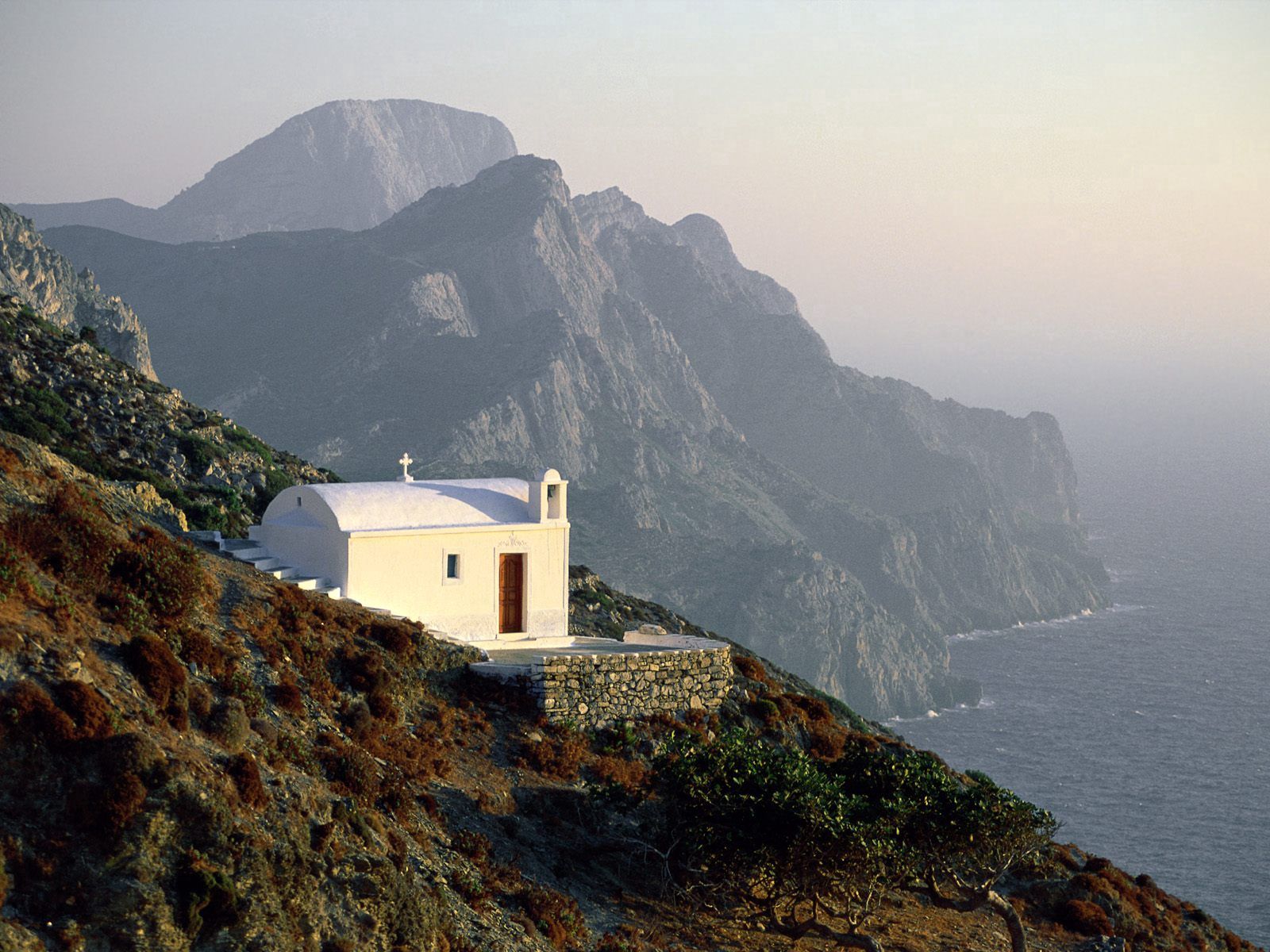 Скачать картинку Греция, Берег, Белый, Высота, Скалы, Природа, Храм в телефон бесплатно.