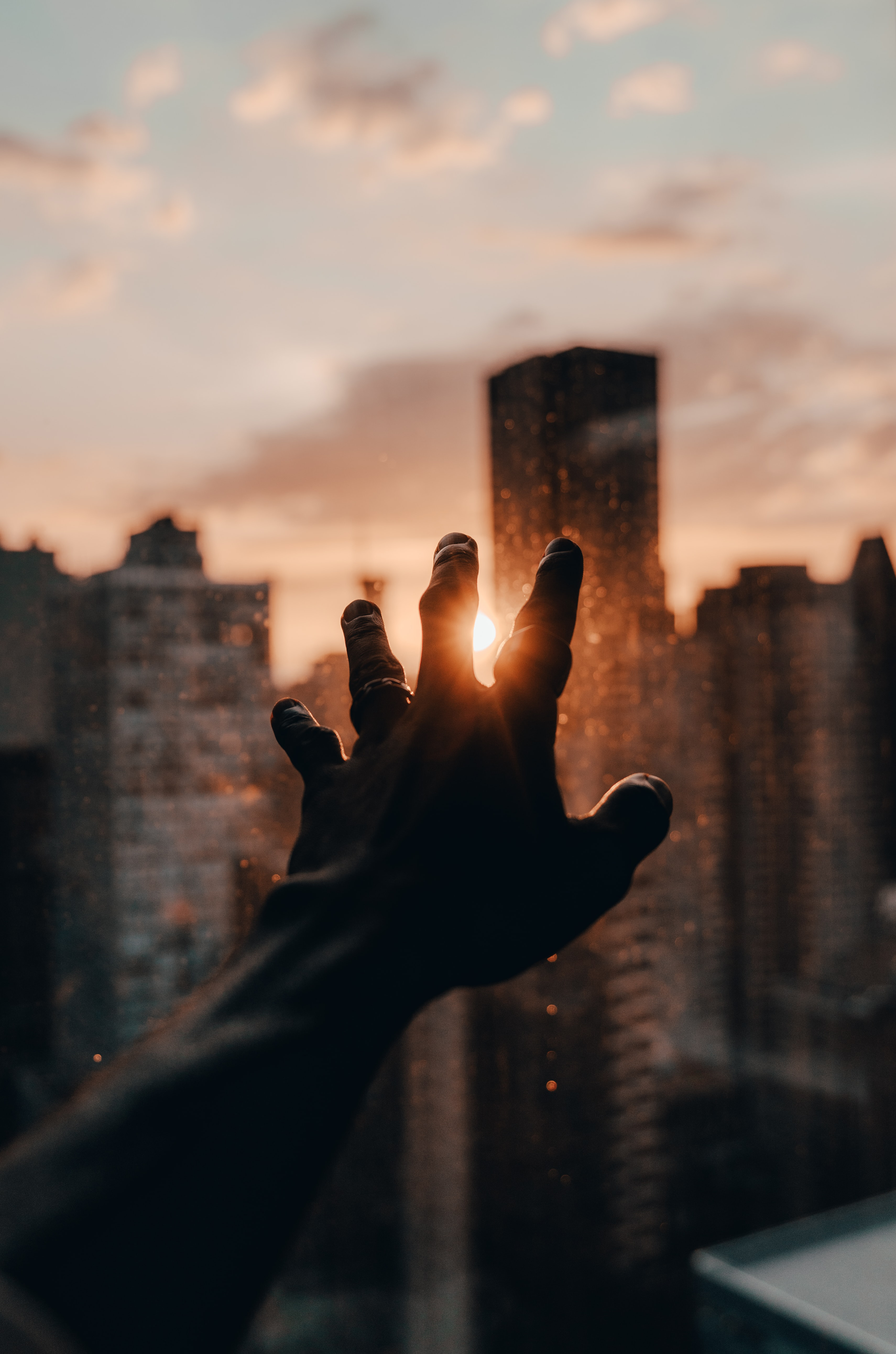 Free download wallpaper Sun, Hand, Miscellanea, Beams, Rays, City, Miscellaneous, Fingers on your PC desktop
