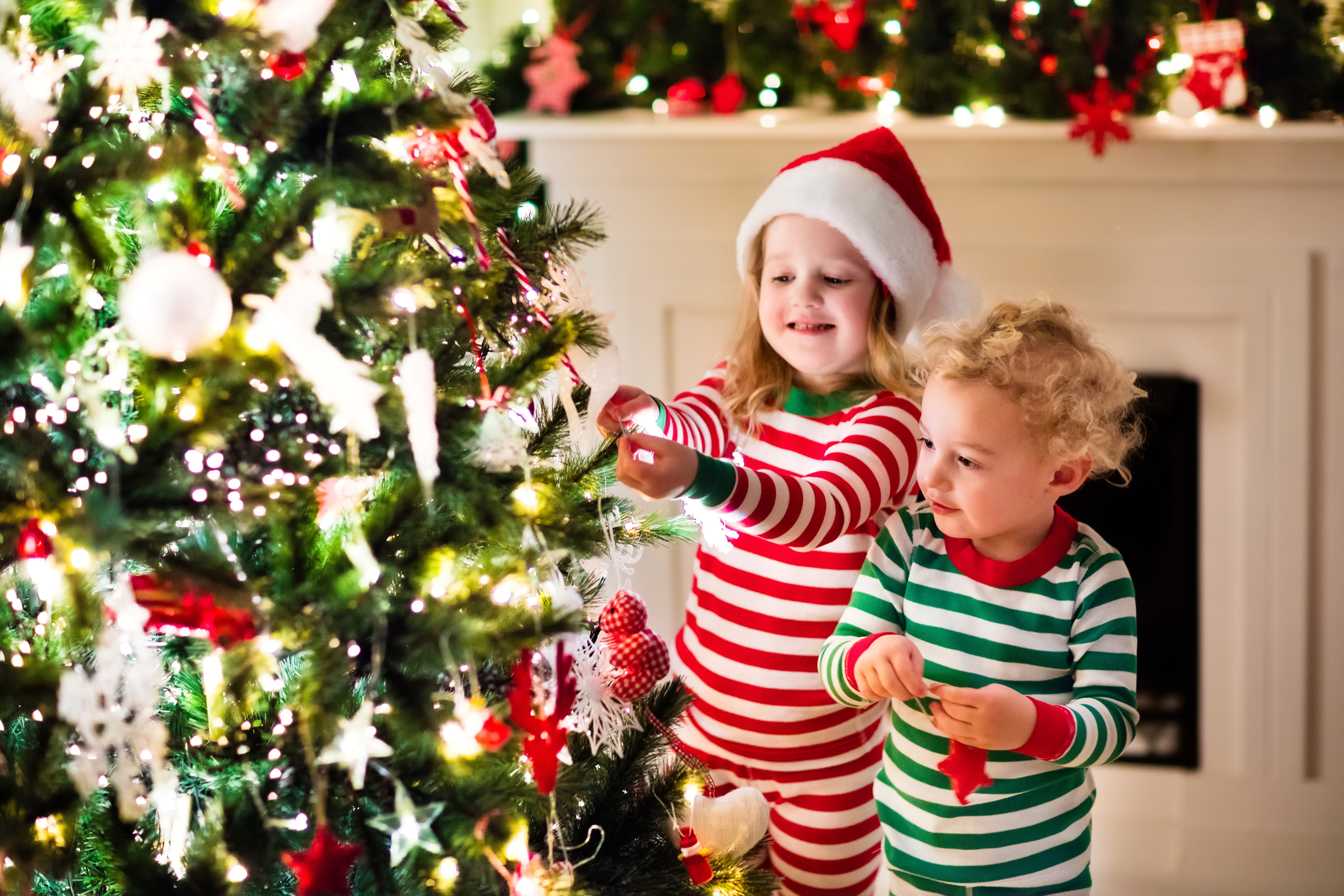 Download mobile wallpaper Christmas, Holiday, Christmas Tree, Child, Little Girl, Santa Hat, Little Boy for free.
