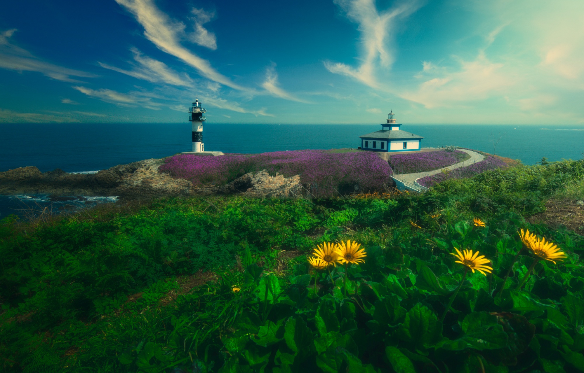 Download mobile wallpaper Nature, Sea, Flower, Vegetation, Bridge, Lighthouse, Island, Spain, Man Made for free.