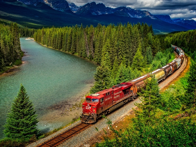 Download mobile wallpaper Landscape, Mountain, Forest, River, Train, Locomotive, Vehicle, Vehicles for free.