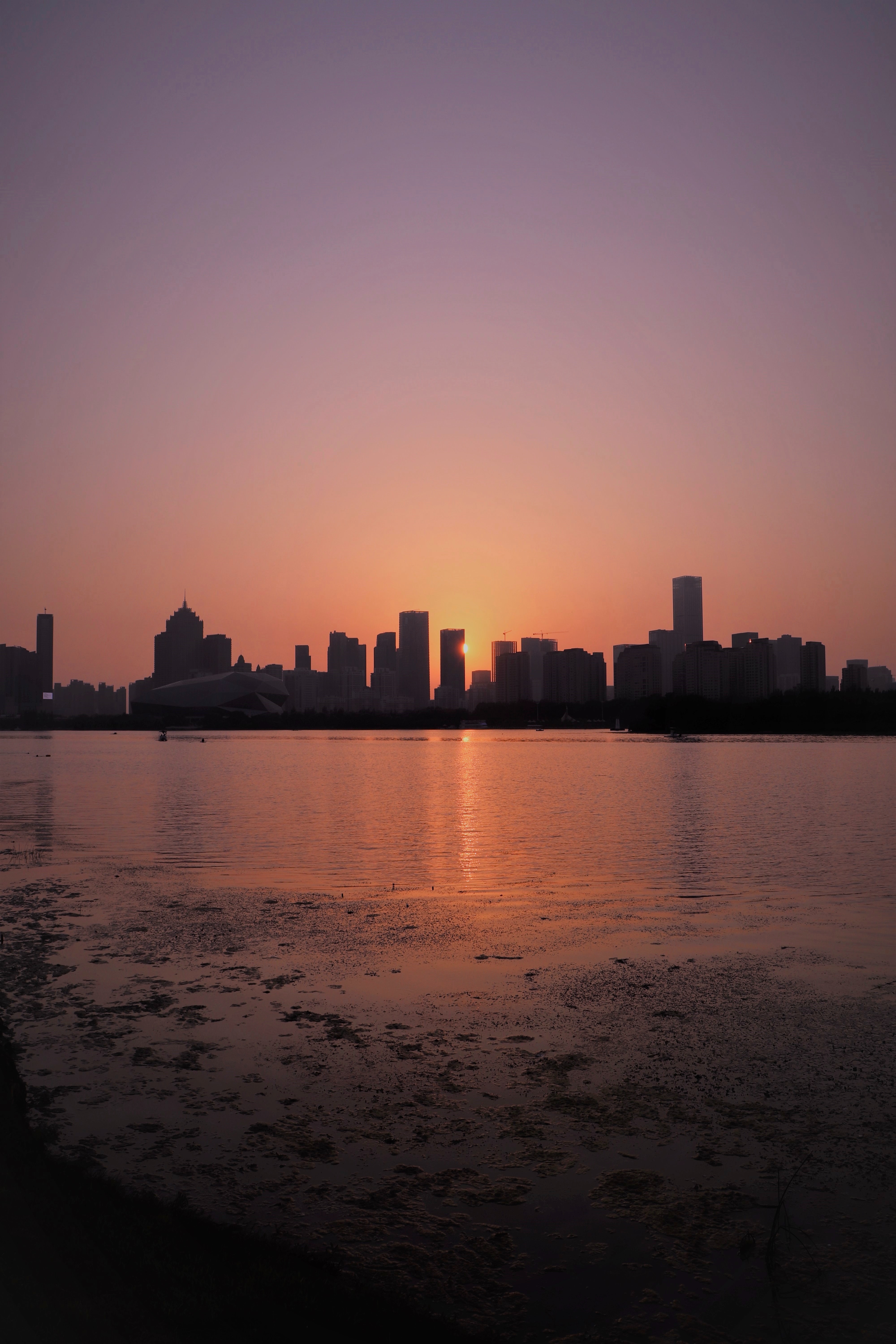 Download background sunset, cities, sea, city, building, beams, rays