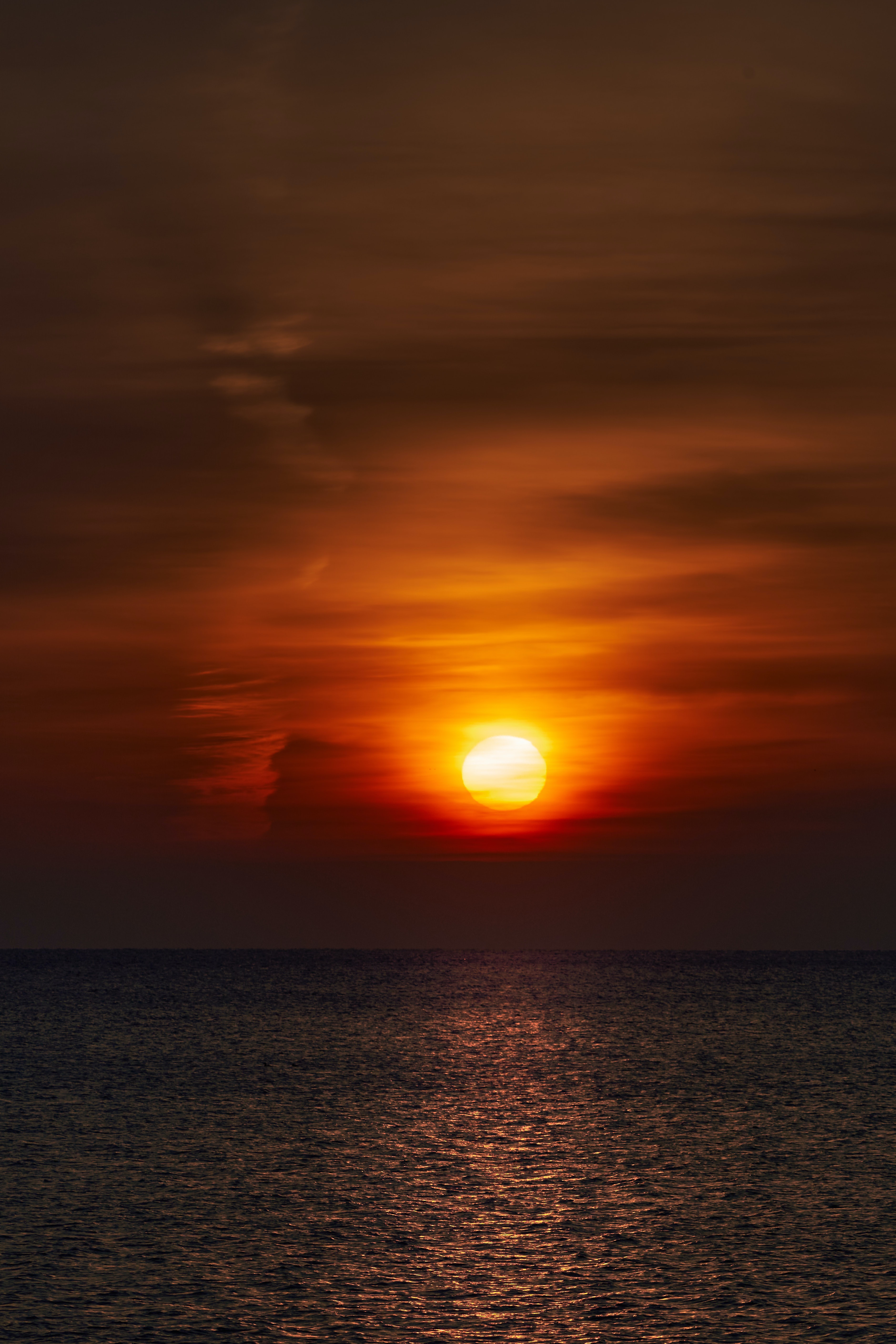 sunset, horizon, glare, dark, water, sky, sun Smartphone Background