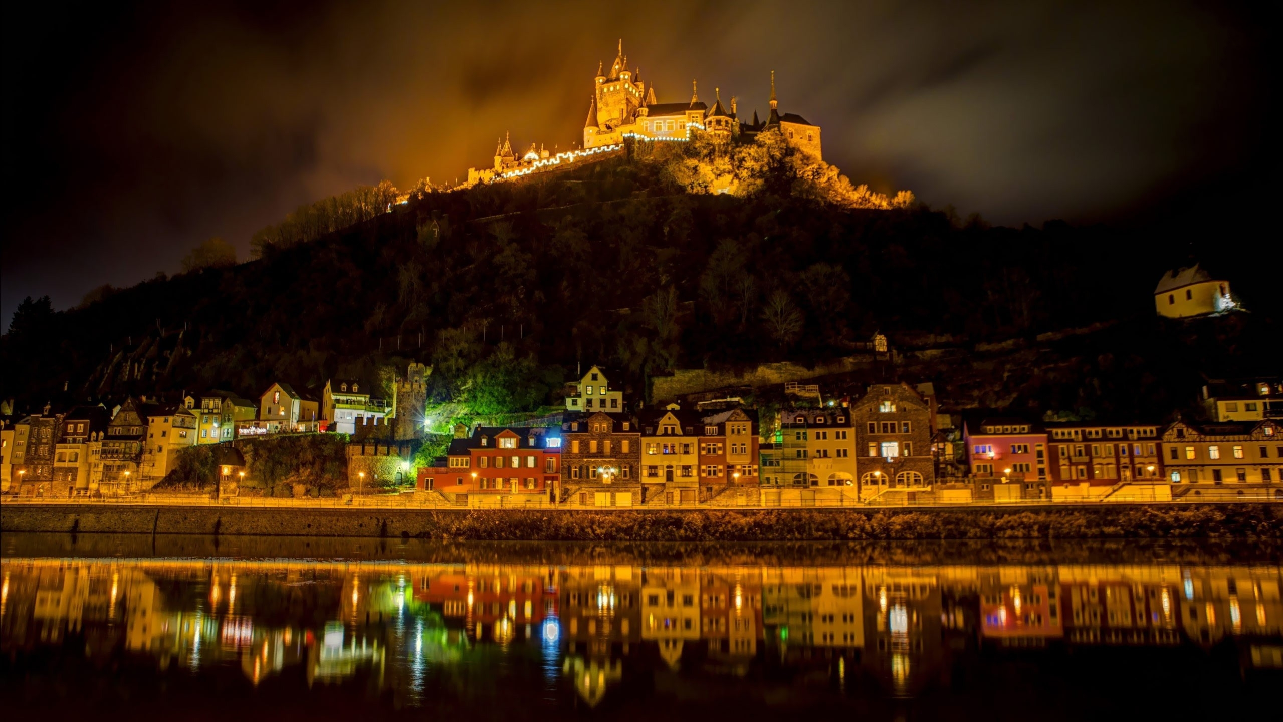 Download mobile wallpaper Night, City, Lake, Light, Hill, Man Made, Castle for free.